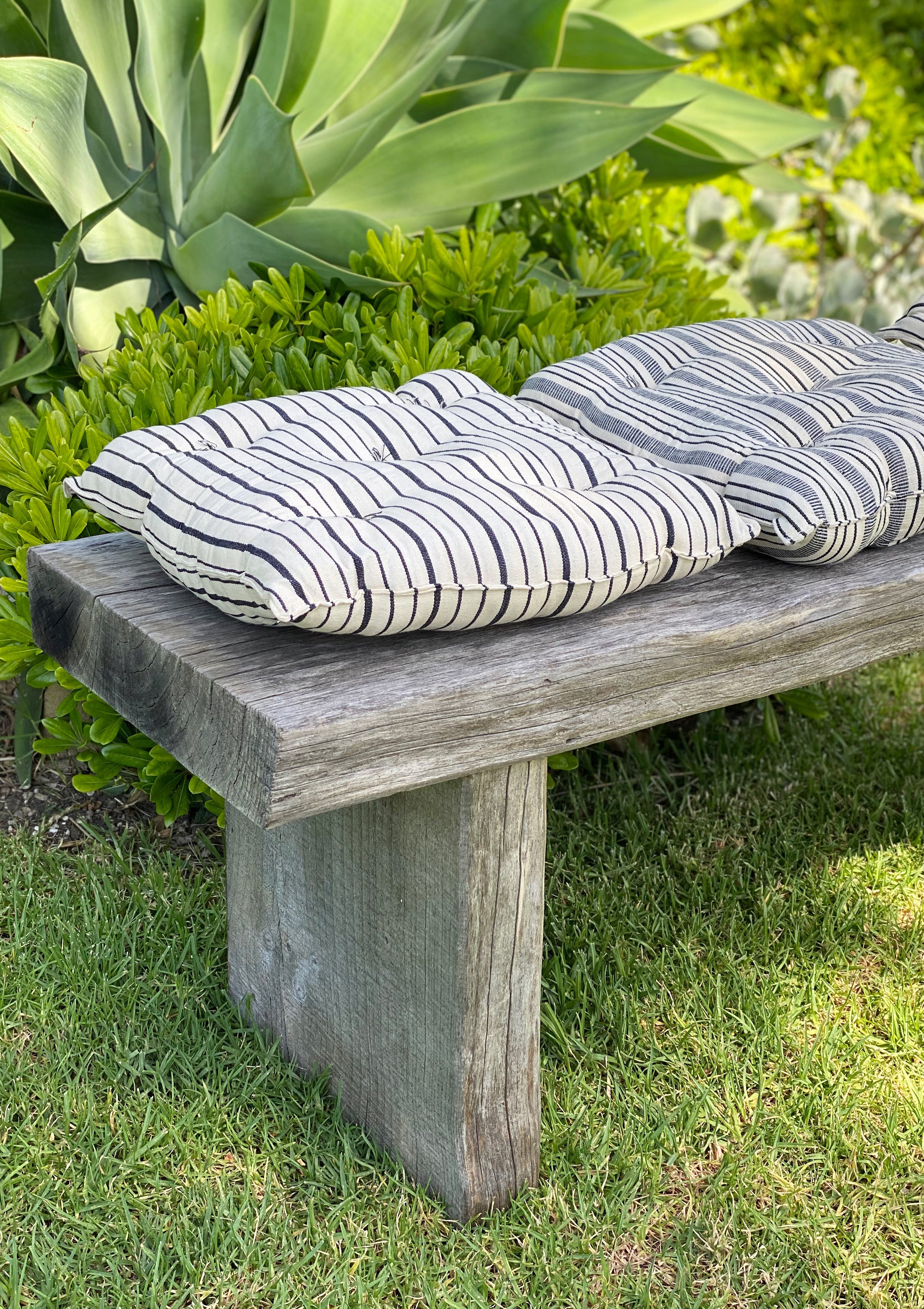 Eco-friendly tufted cushion in a striped design, crafted from hand-dyed cotton by artisans in Guinea for the Tensira x DIANI collaboration.