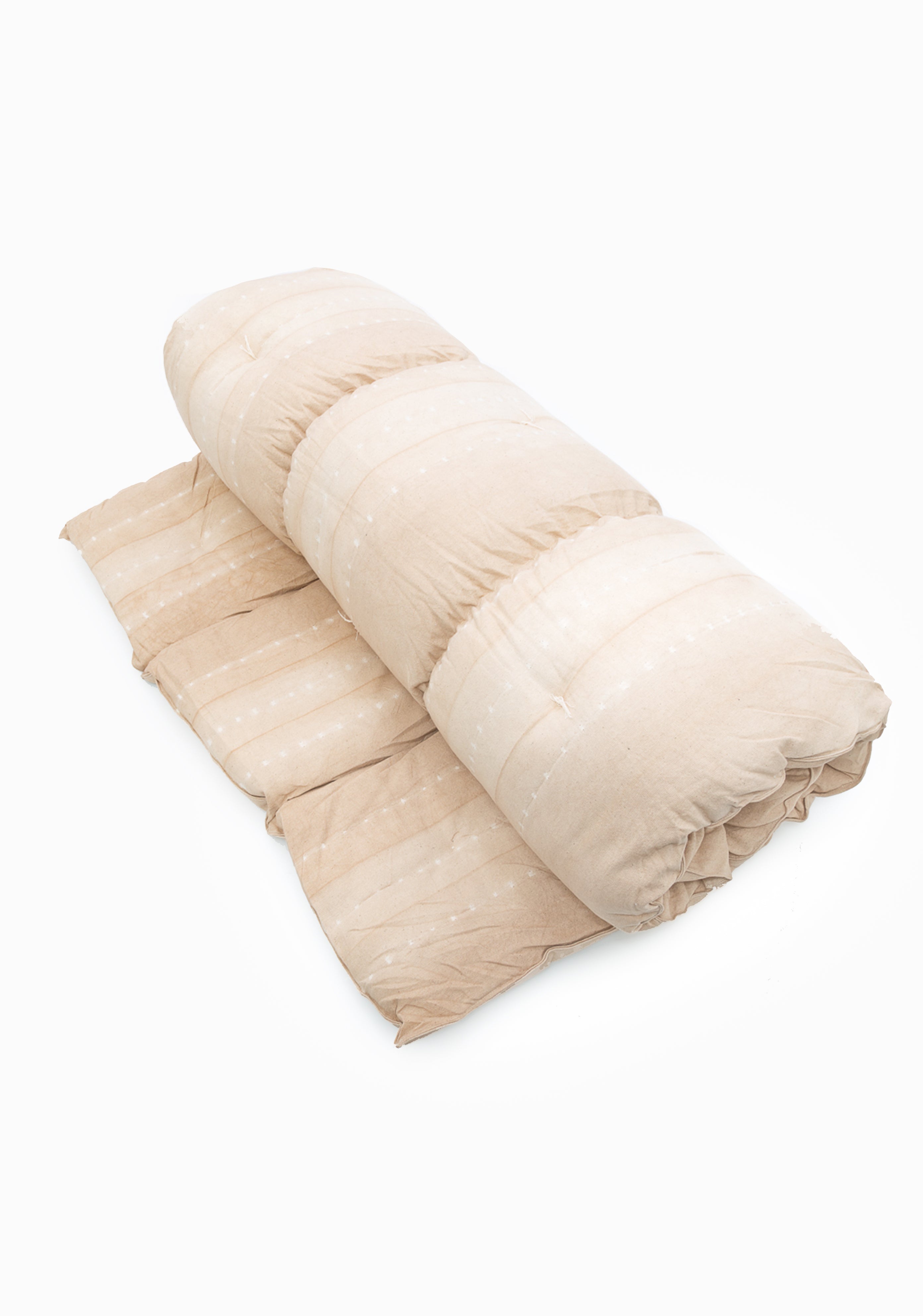 Striped cotton bed roll from the DIANI x Tensira collection, ideal for relaxed garden picnics and sustainable outdoor living.
