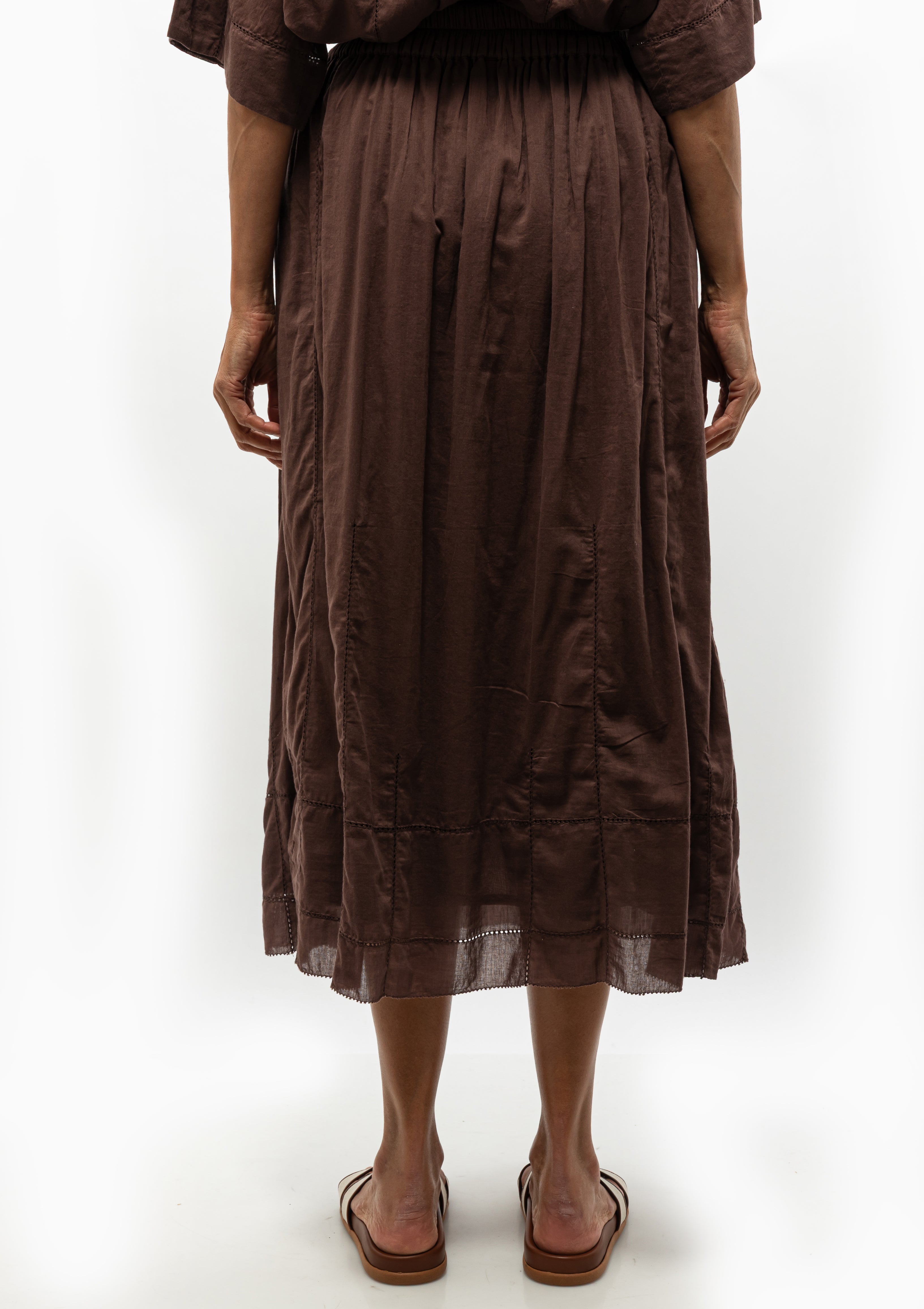 The Mirth Verona Skirt in Grappa brings effortless flair to everyday dressing. Shown with the Mirth Kyoto shirt and the Ancient Greek Sandal Desmos Footbed. Available at Diani Boutique.