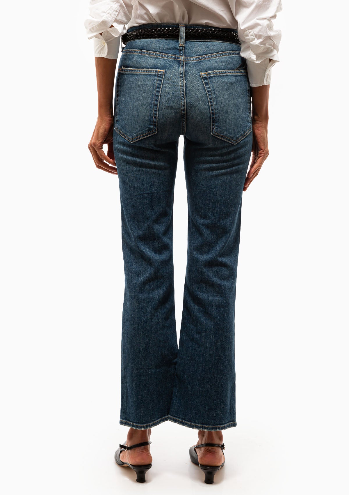 The Boot Cut Jean in Classic Wash worn with a white button down blouse and the Reine Braided Black Belt. Available at Diani.