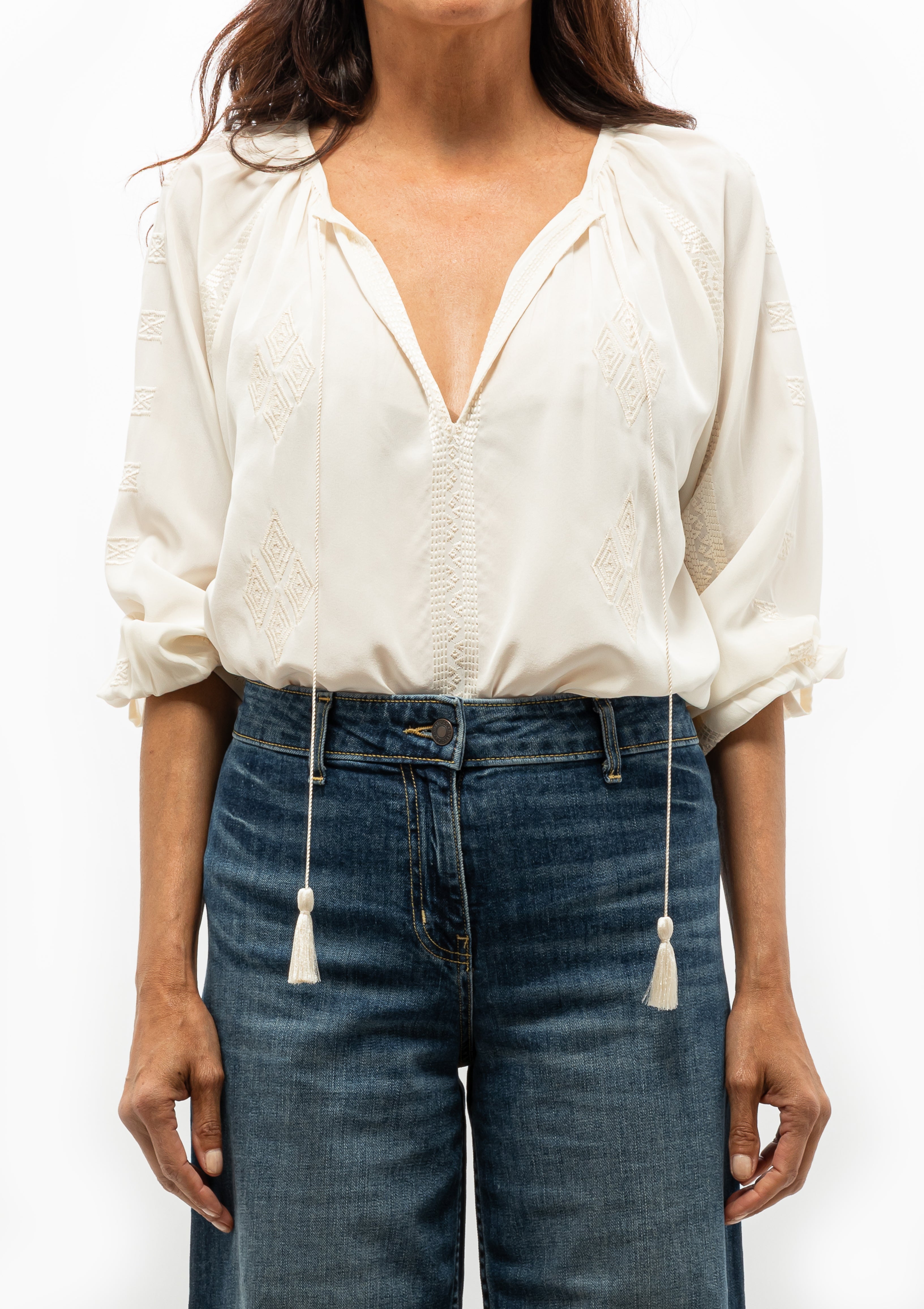 Nili Lotan Cristo Silk Blouse in Ivory featuring tonal Indian embroidery and delicate tassel ties — available at Diani Boutique.