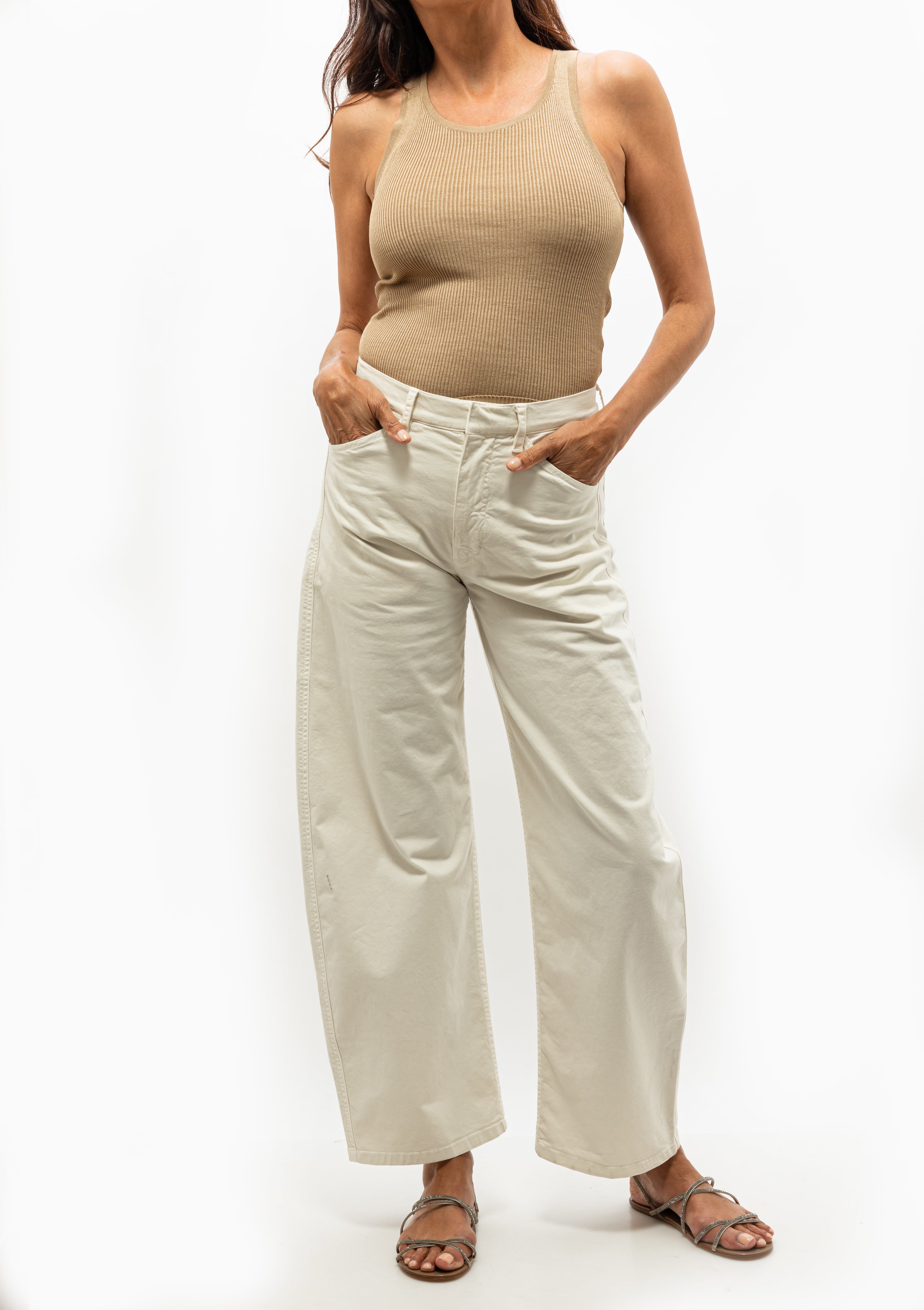Woman wearing ribbed camel colored Lottie tank top from Nili Lotan, available at Diani Boutique.