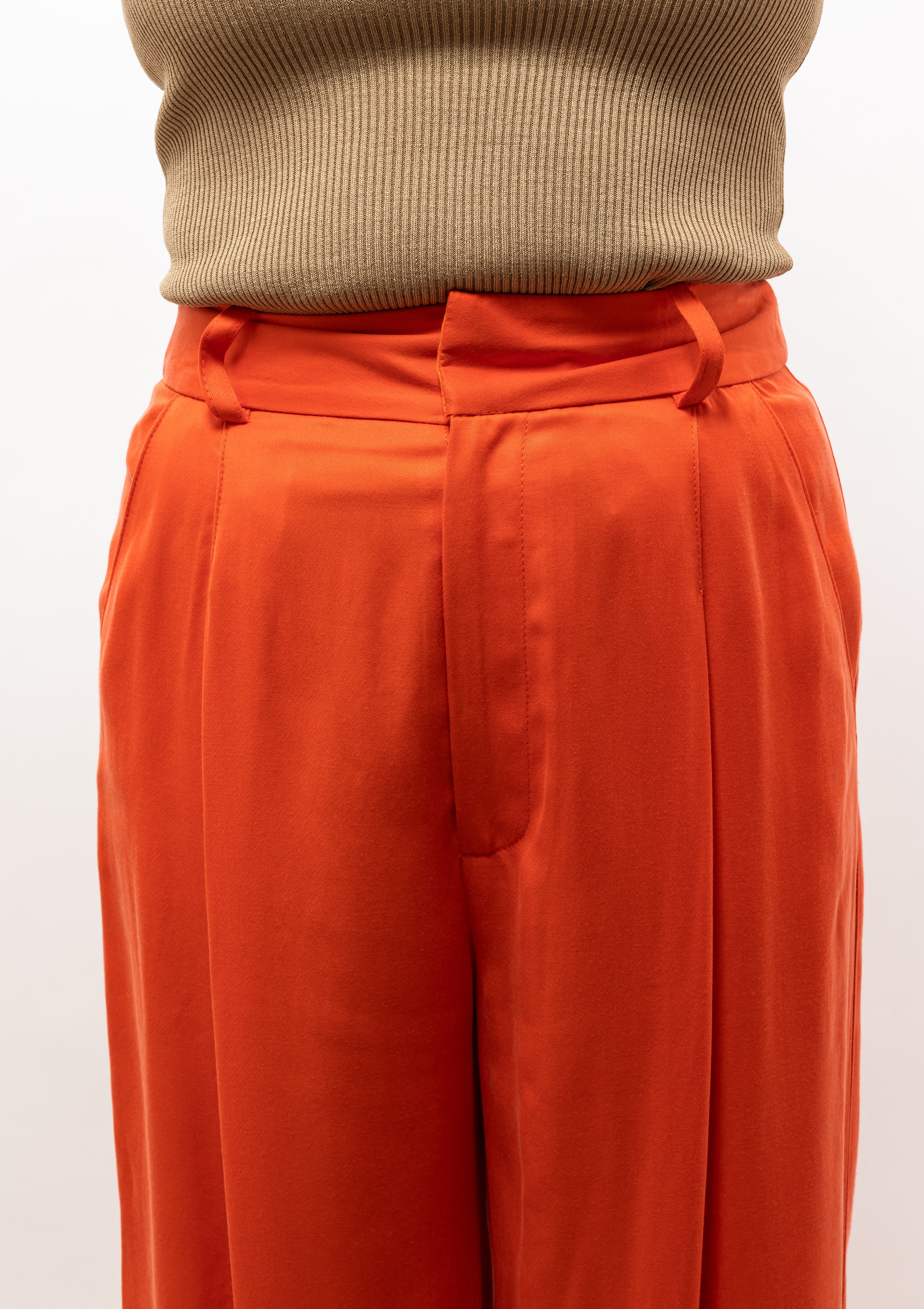 Vibrant Nili Lotan Pleated pants in a bold vermillion hue. Available at Diani Boutique.