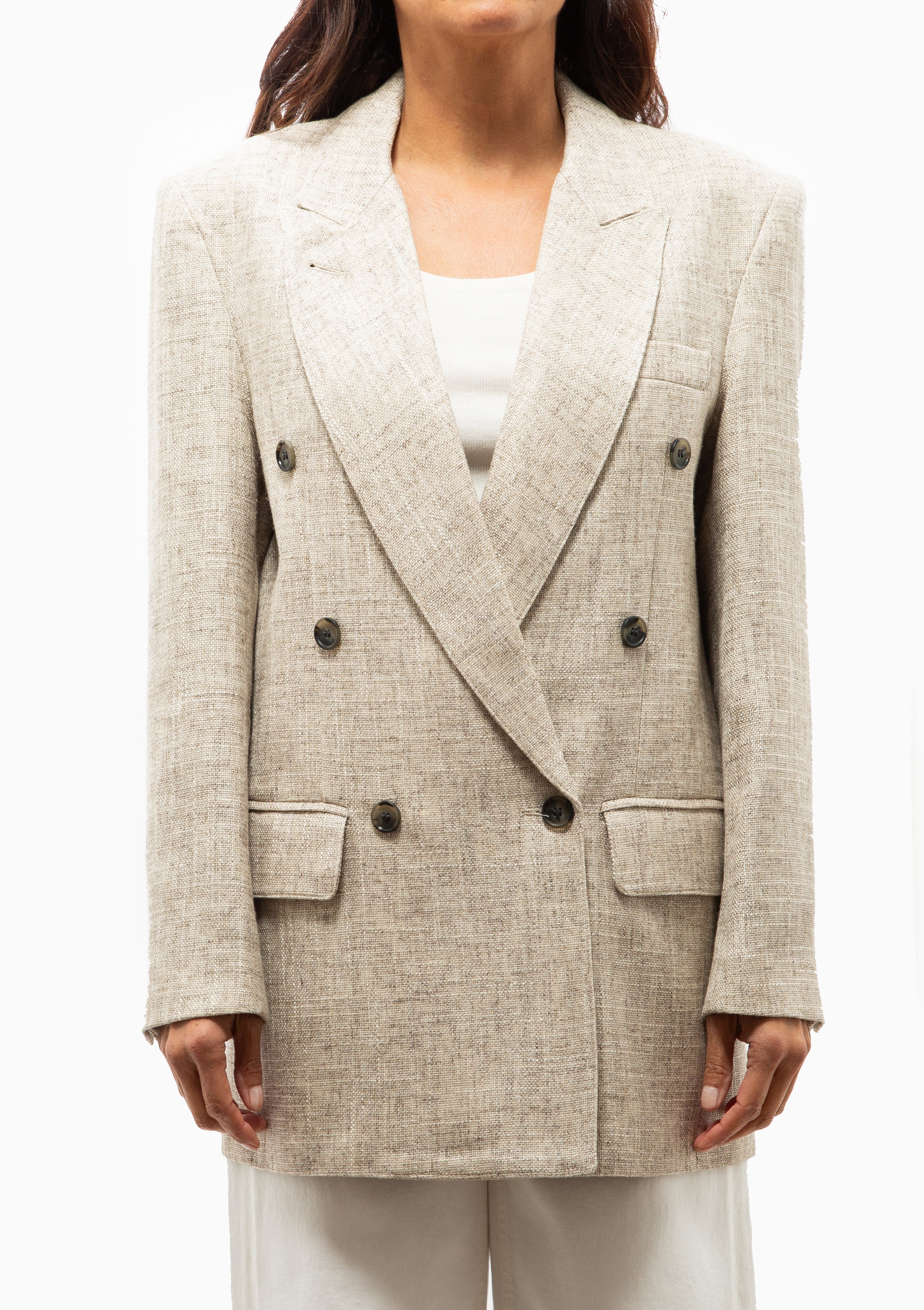 Close-up of a double-breasted Smythe linen tweed blazer with peaked lapels and a relaxed, oversized fit.