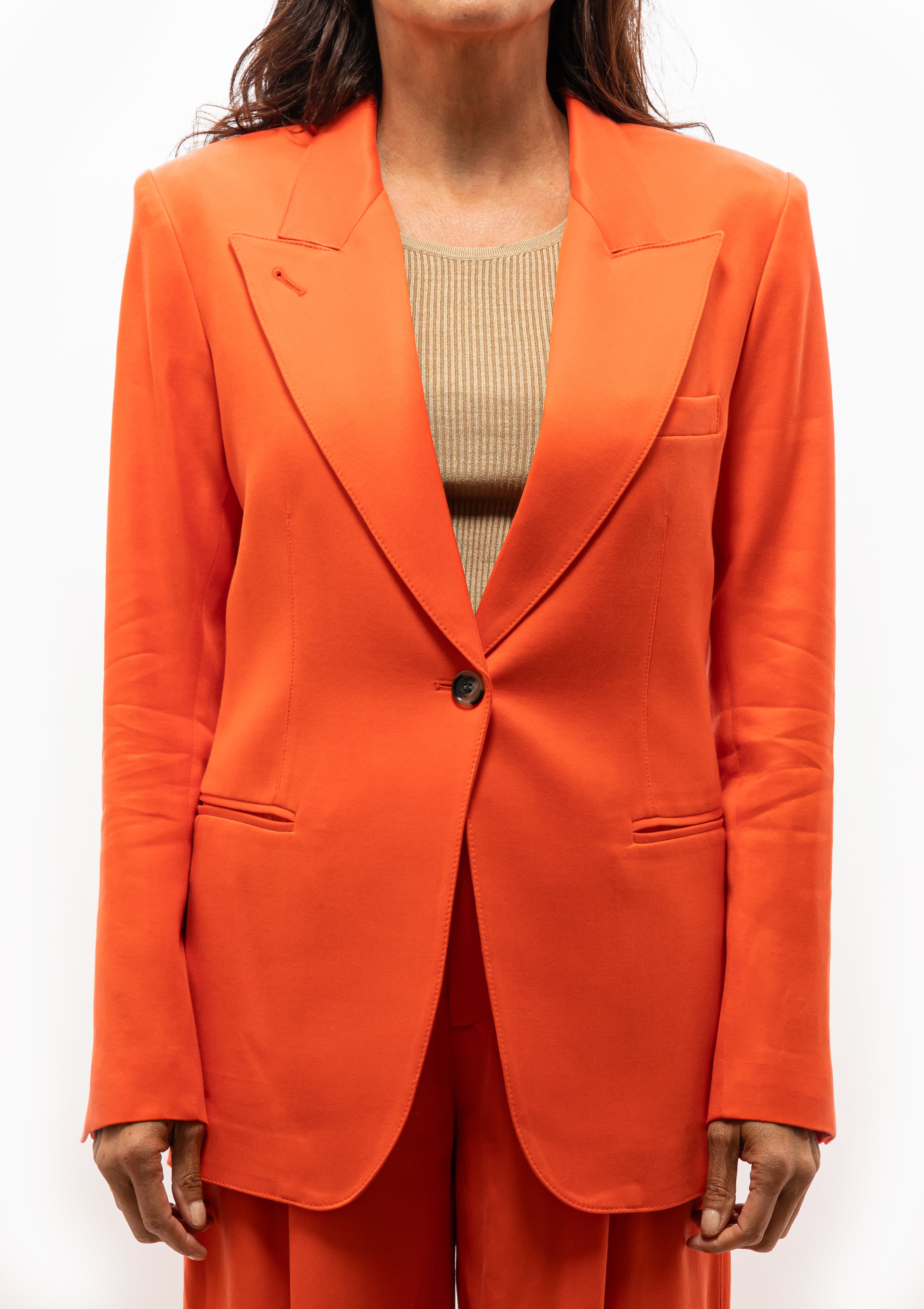 Tailored Smythe 90's Blazer in Vermillion orange blazer paired with high-waisted pants. Available at Diani Boutique.