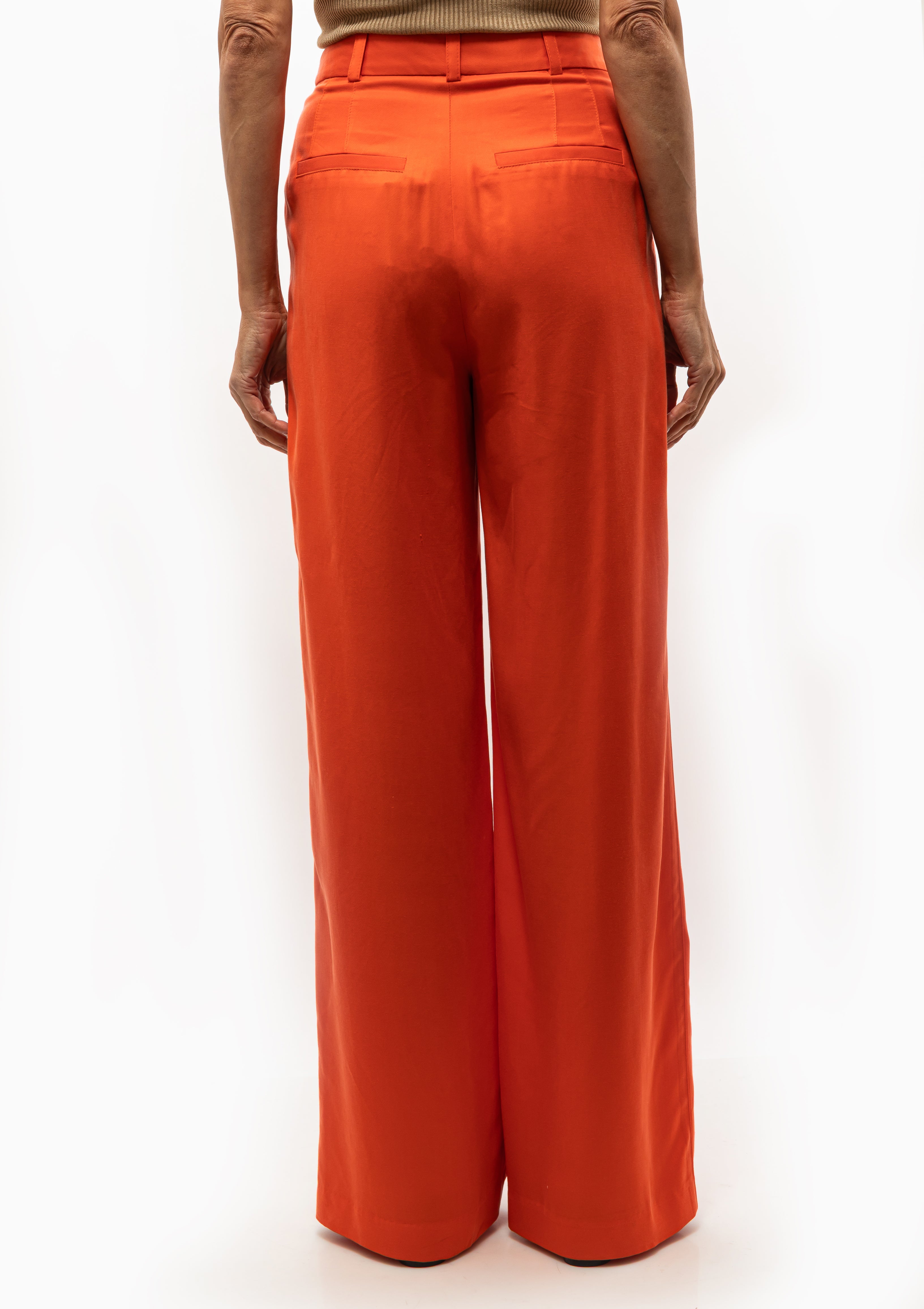 Smythe Pleated Trouser in Vermillion. Wide-leg orange pants with a structured fit. Available at Diani Boutique.
