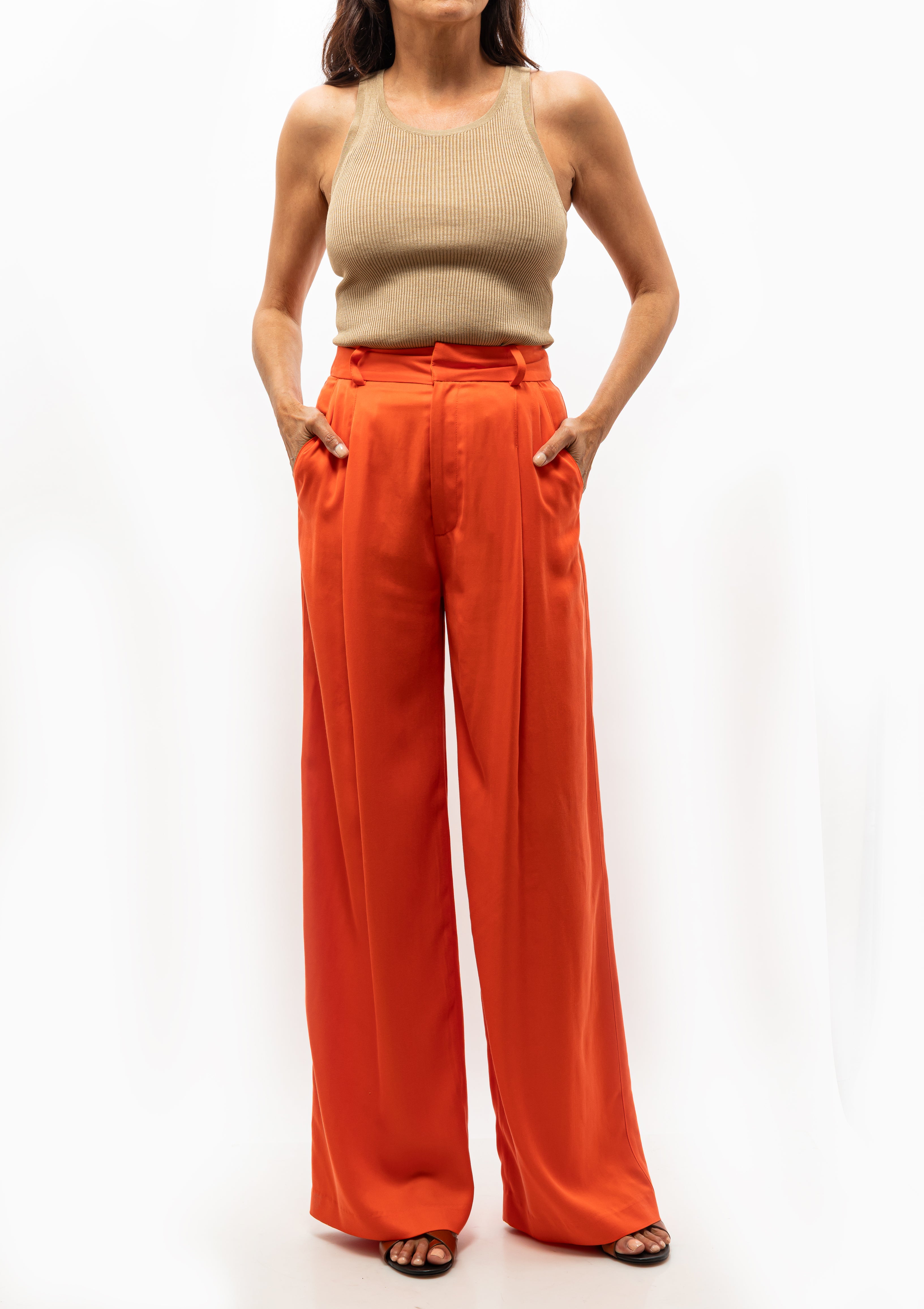 Bright orange pleated trousers by Smythe styled with matching blazer. Available at Diani Boutique.