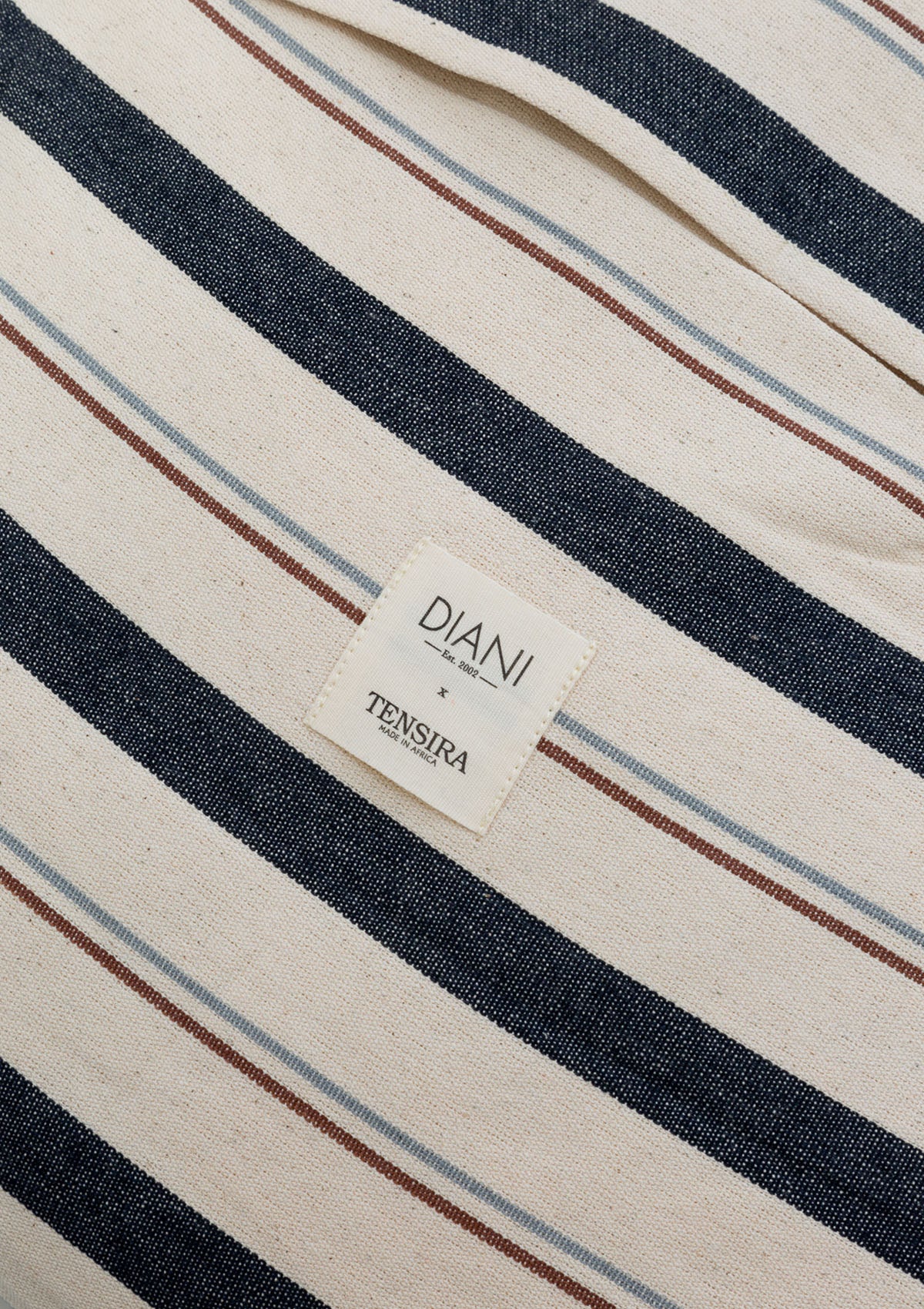 Hand-dyed cotton pillow in a 12" x 20" size with a clean striped or solid finish, part of the exclusive Tensira x Diani Boutique collection.