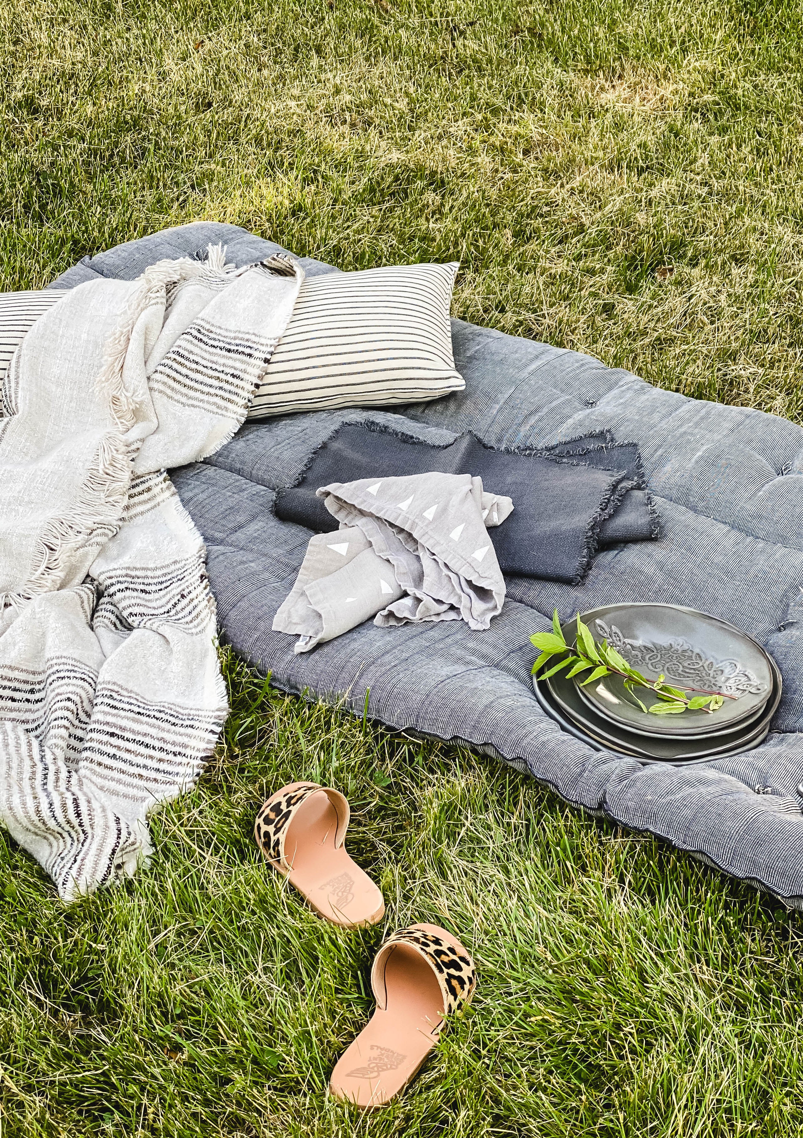 Handwoven picnic bed roll in earthy tones, crafted from 100% cotton by artisans in Guinea for the DIANI x Tensira collaboration. Perfect for your next impromptu picnic.