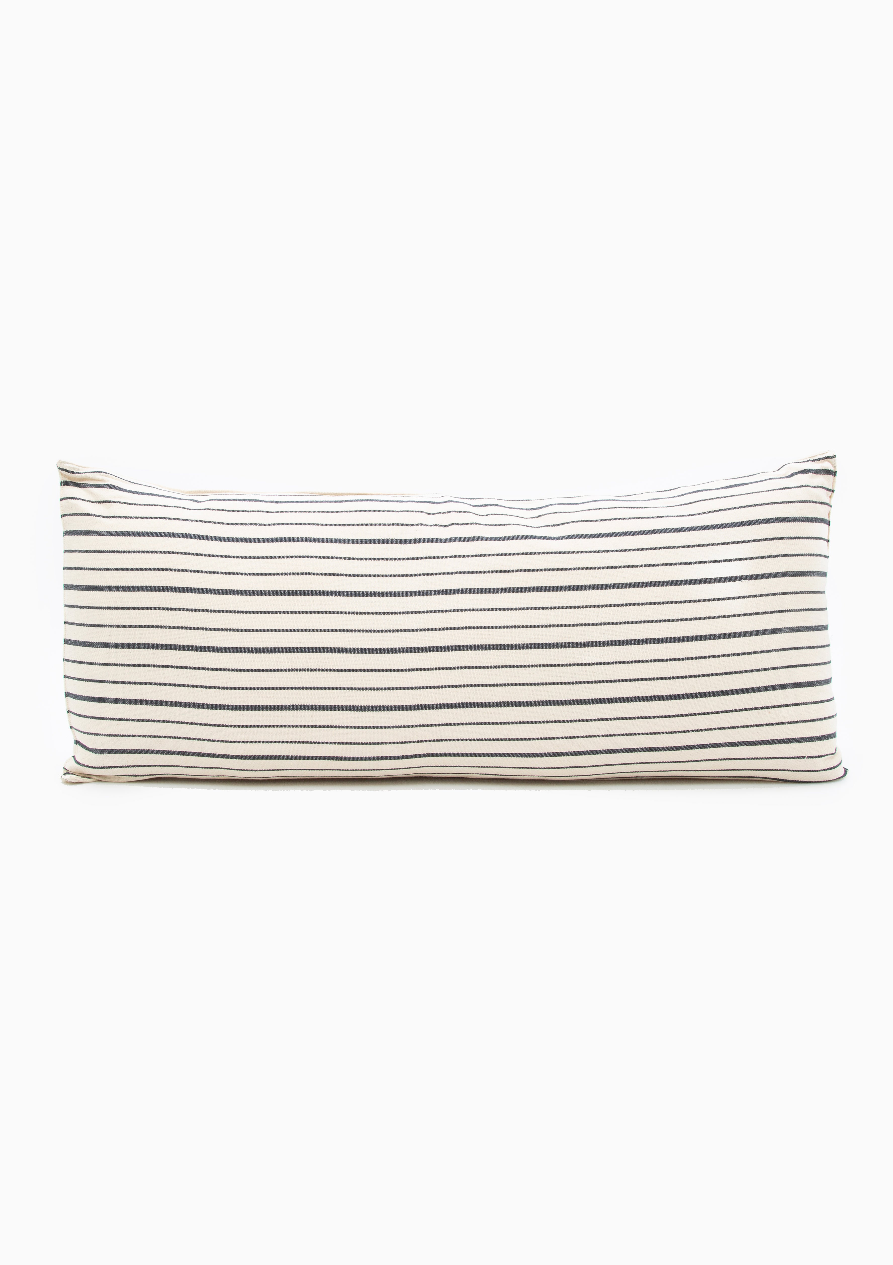Eco-conscious long cushions in a mix of solid and striped patterns, featuring hand-dyed yarns and artisan-made cotton fabric from Guinea. Perfect for a quick afternoon nap or picnic in the garden. Available at Diani Boutique.