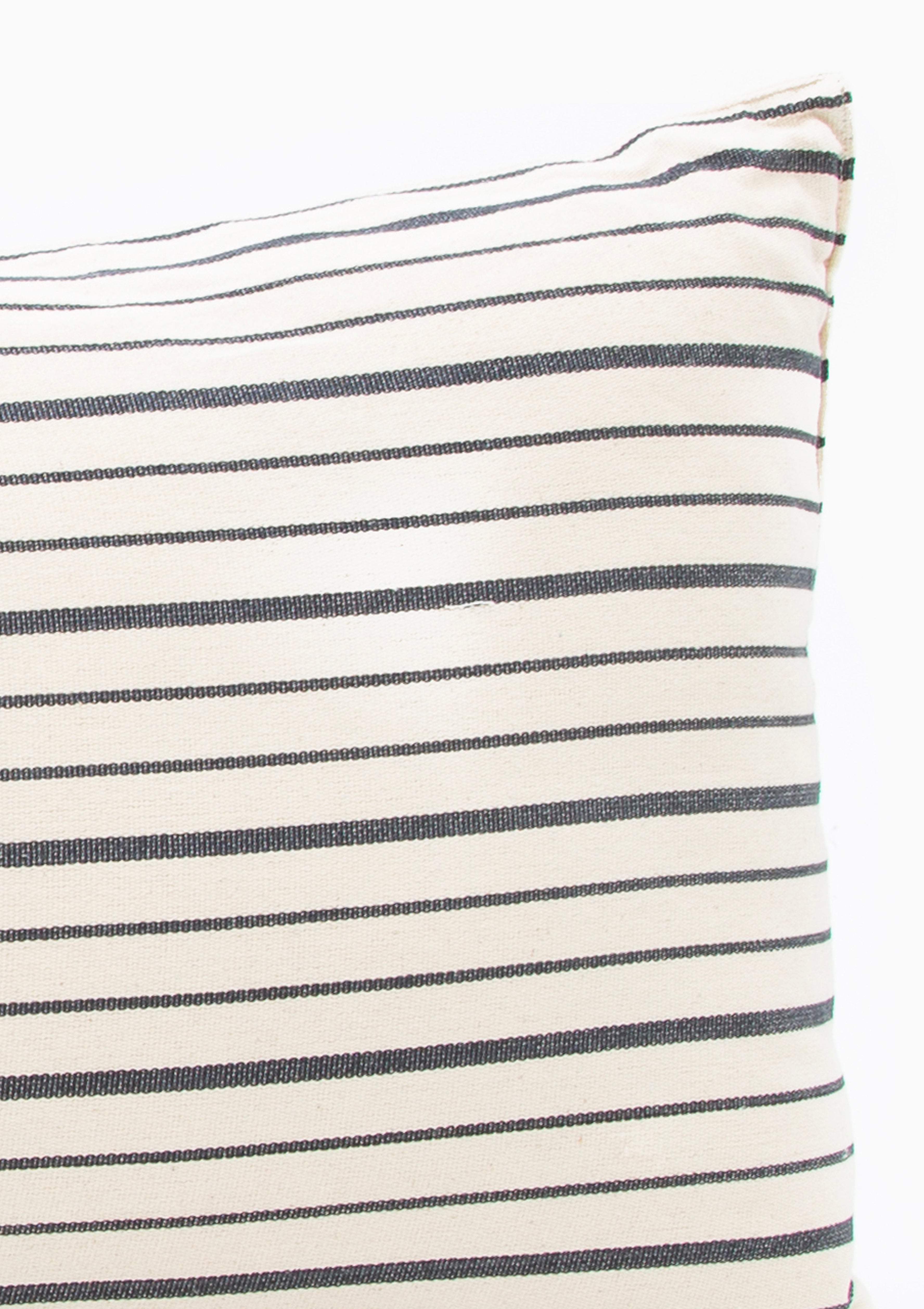 Eco-conscious long cushions in a mix of solid and striped patterns, featuring hand-dyed yarns and artisan-made cotton fabric from Guinea. Available at Diani Boutique.