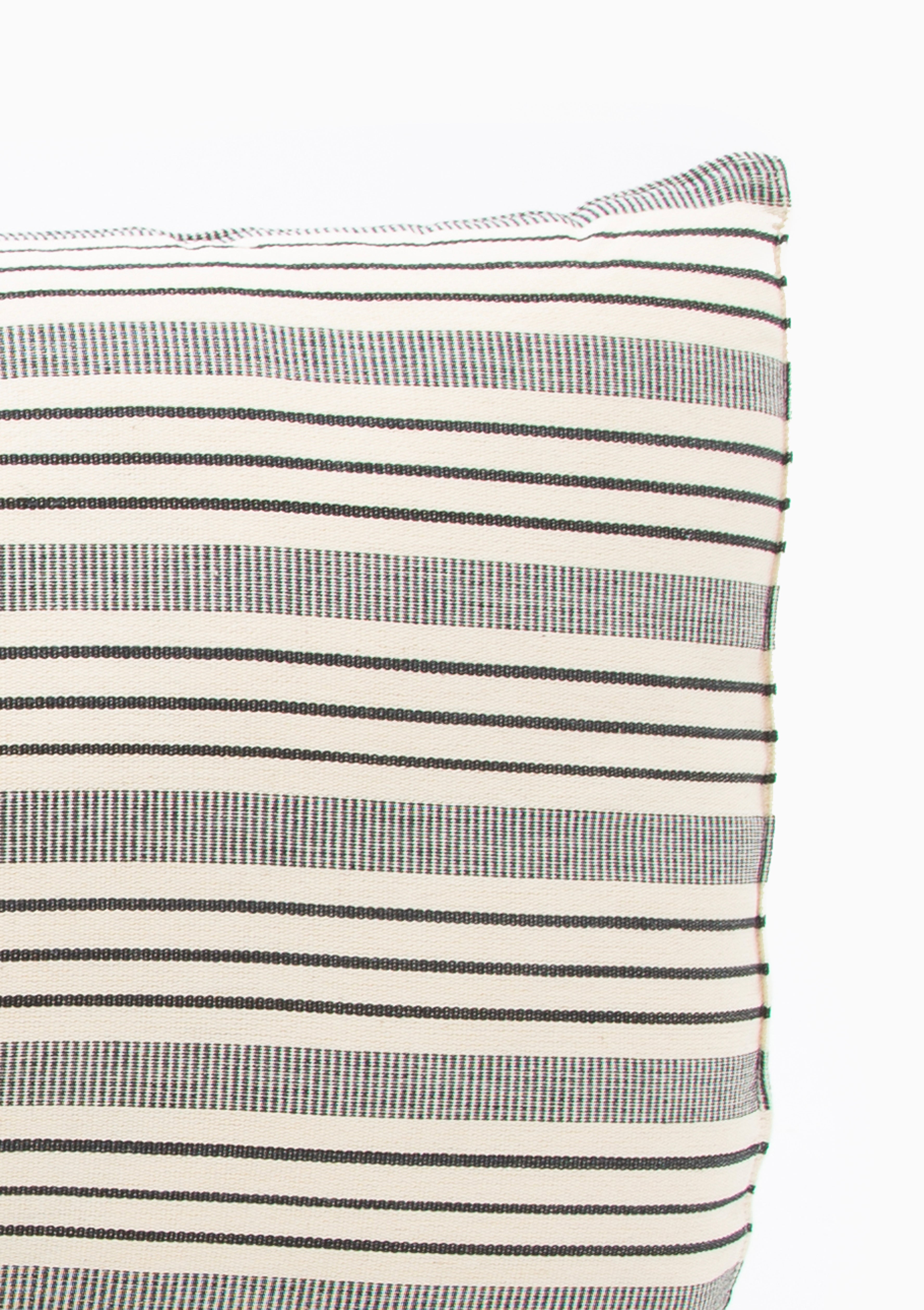 Hand-dyed long cushions with minimalist stripes and natural tones, made on traditional looms from 100% cotton by Tensira artisans.
