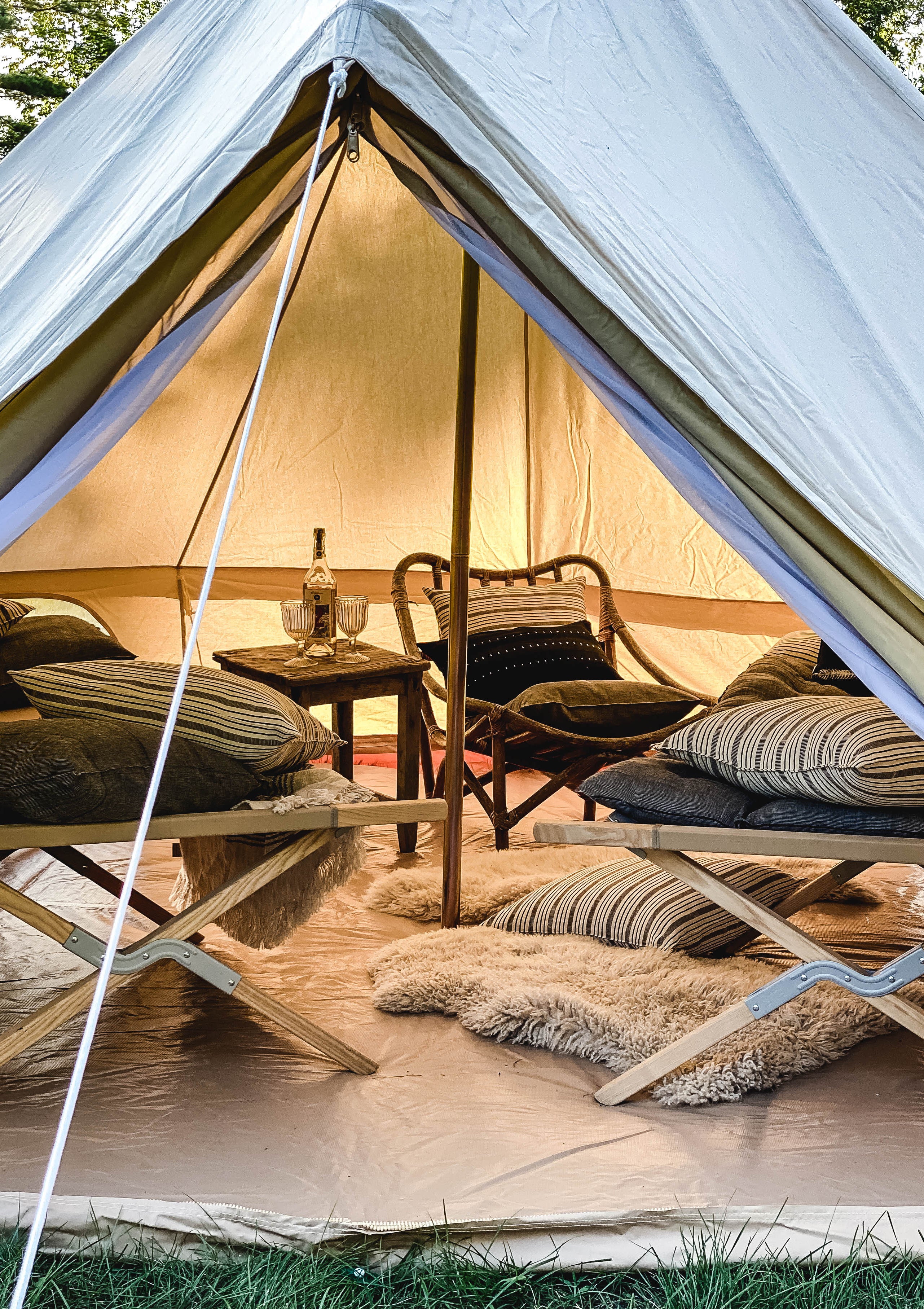 Tensira headboard cushion in soft, natural tones, featuring hand-dyed yarns and traditional weaving techniques, shown in our outdoor tent to elevate your garden campout experience.
