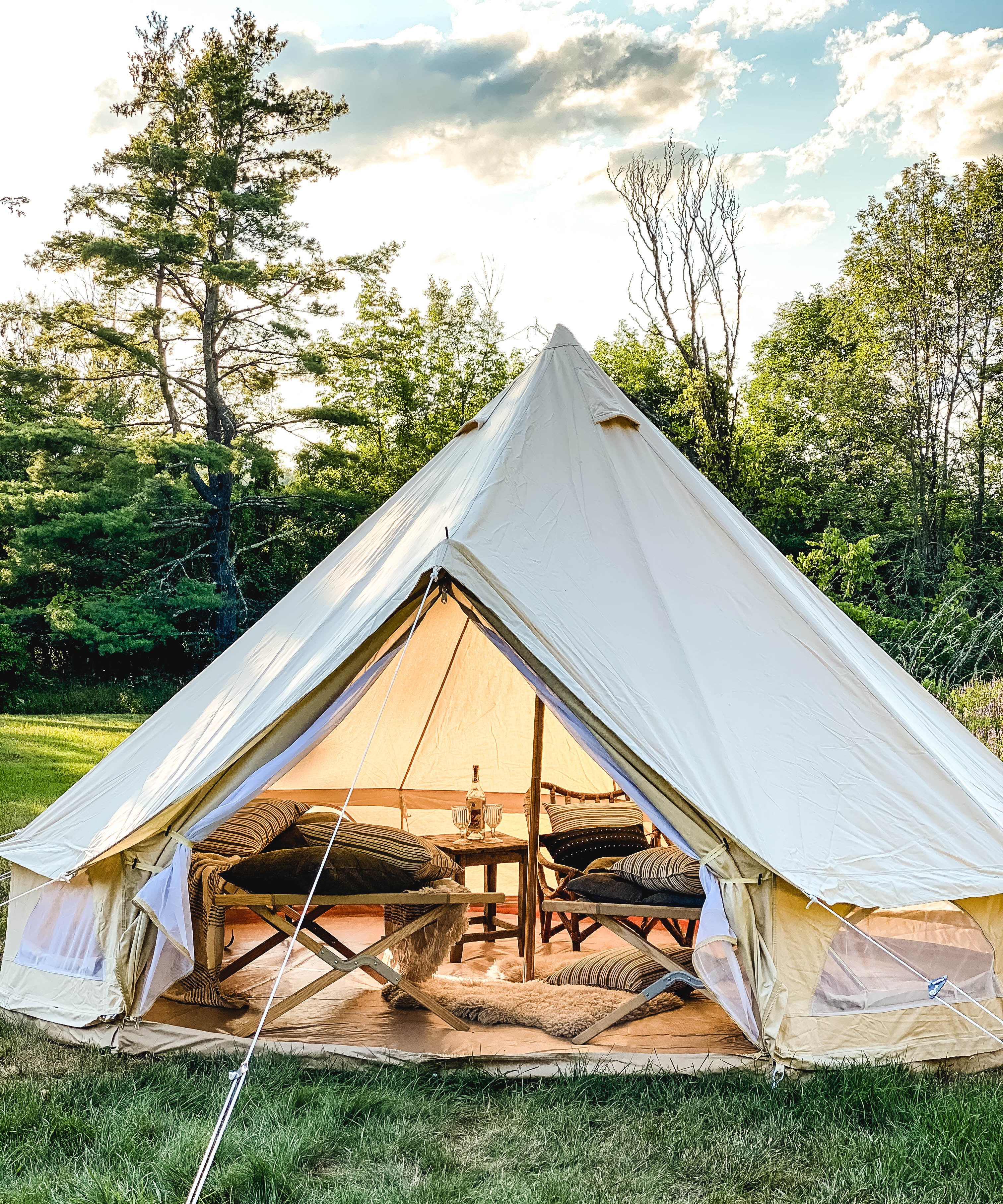 Tensira headboard cushion in soft, natural tones, featuring hand-dyed yarns and traditional weaving techniques, shown in our outdoor tent to elevate your garden campout experience.