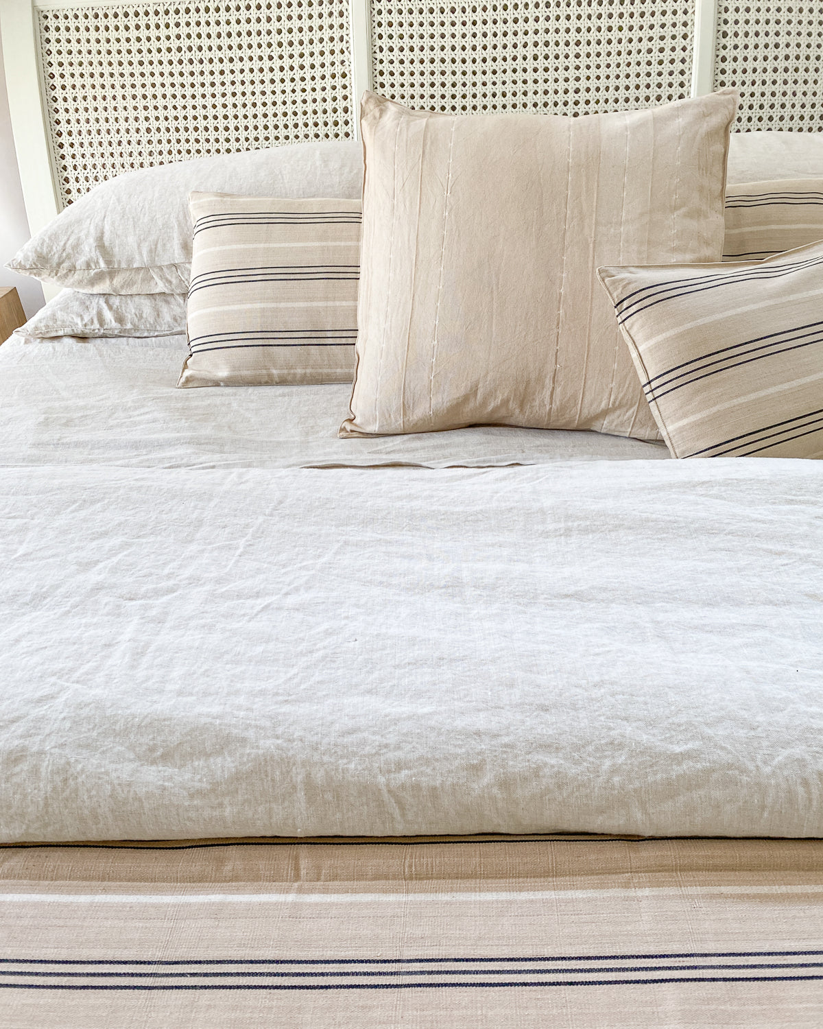Long bolster pillow featuring a hand-dyed pattern, made from artisan-crafted cotton in a 14" x 48" size. May be used indoors or outdoors and available exclusively at Diani Boutique.