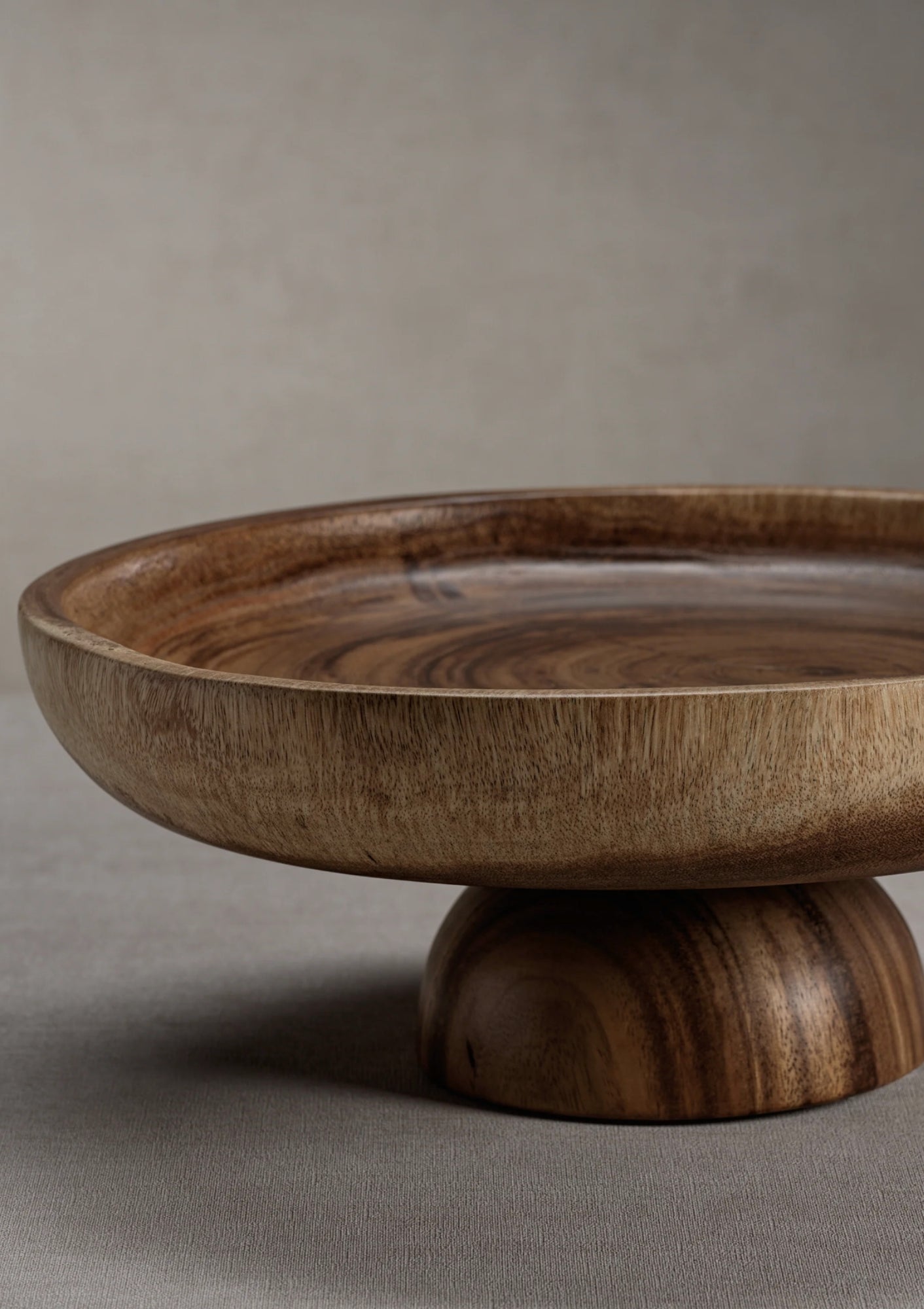 Javanese acacia wood pedestal serving bowl available at Diani.