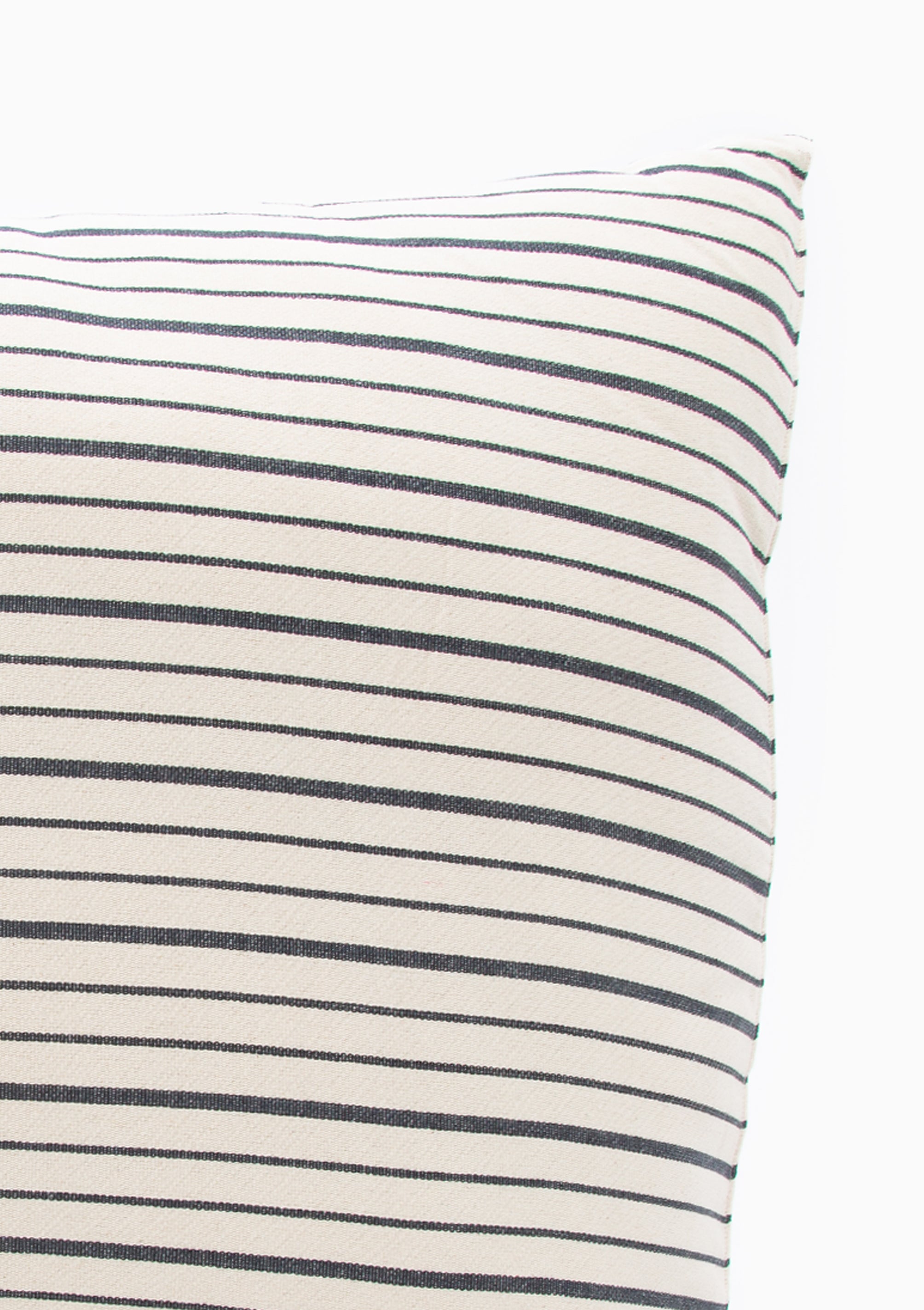 Closeup of our striped cotton headboard cushion from Tensira, sustainably made in Guinea by artisan groups using zero-waste practices.