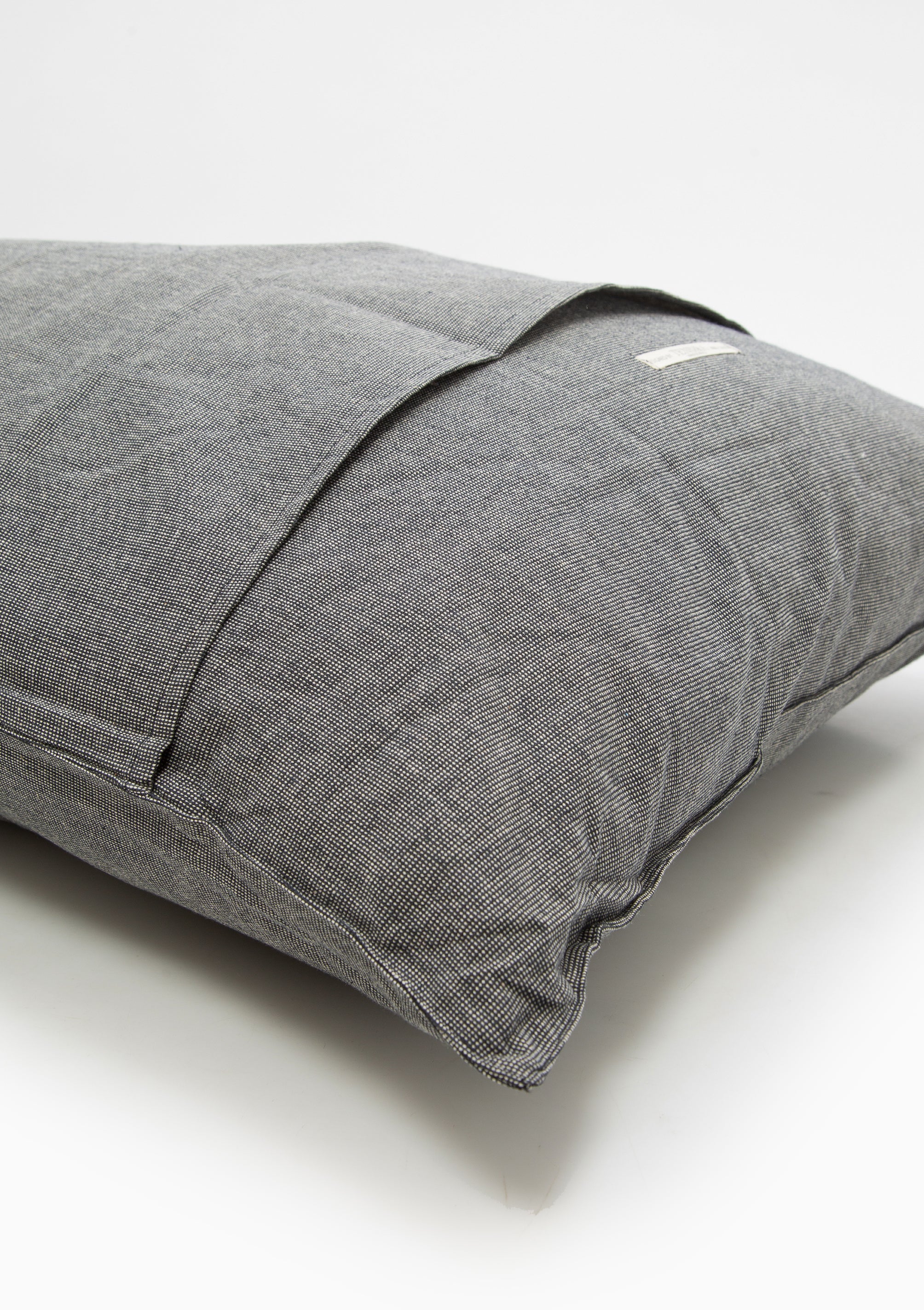 Our removable handwoven 100% cotton headboard cushion by Tensira, crafted on traditional looms with over 3,000 hand-dyed yarns.