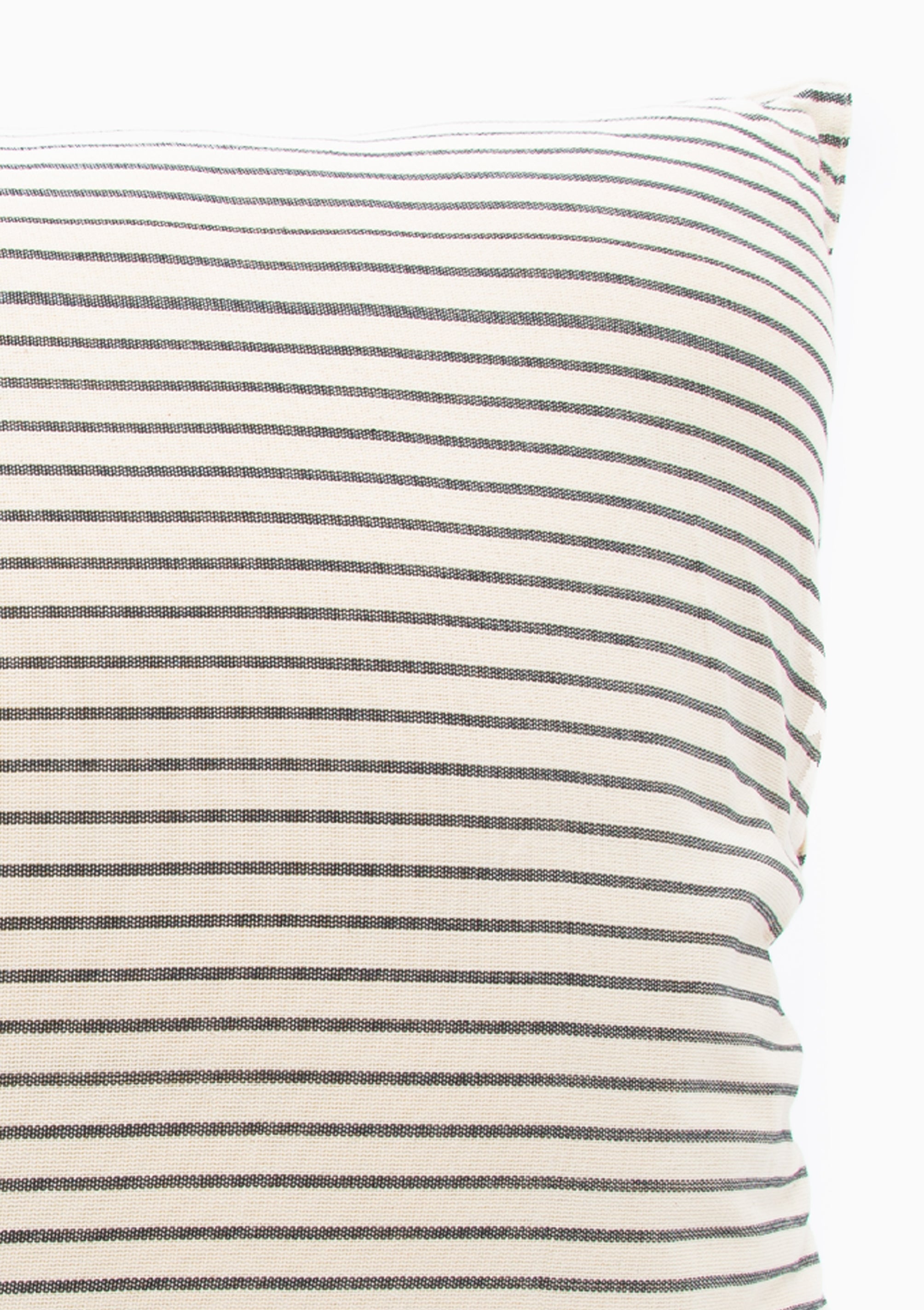 Close up of our striped cotton headboard cushion from Tensira, sustainably made in Guinea by artisan groups using zero-waste practices.