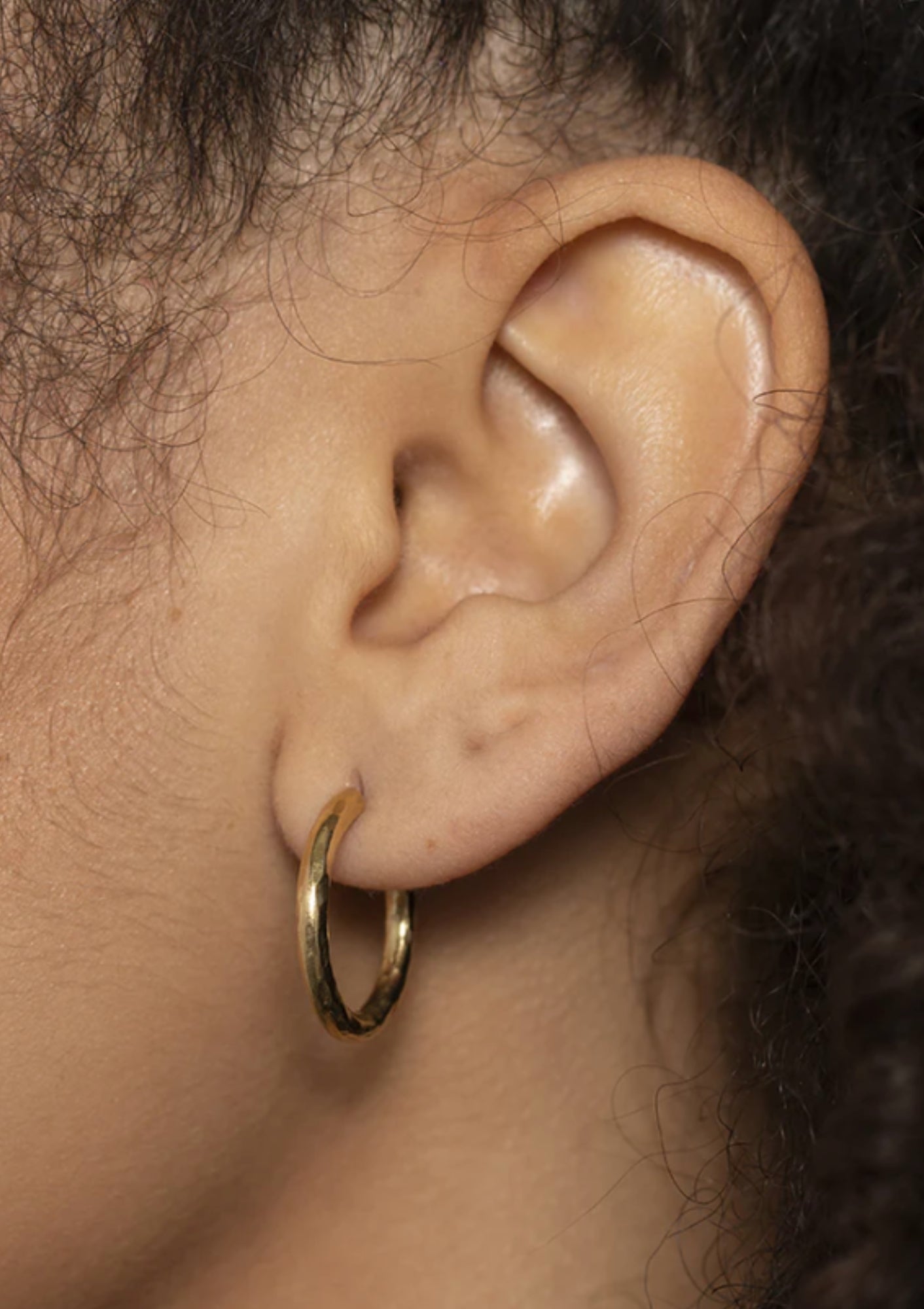 Small Hammered Hoop Earrings in Gold by Soko, available at Diani.