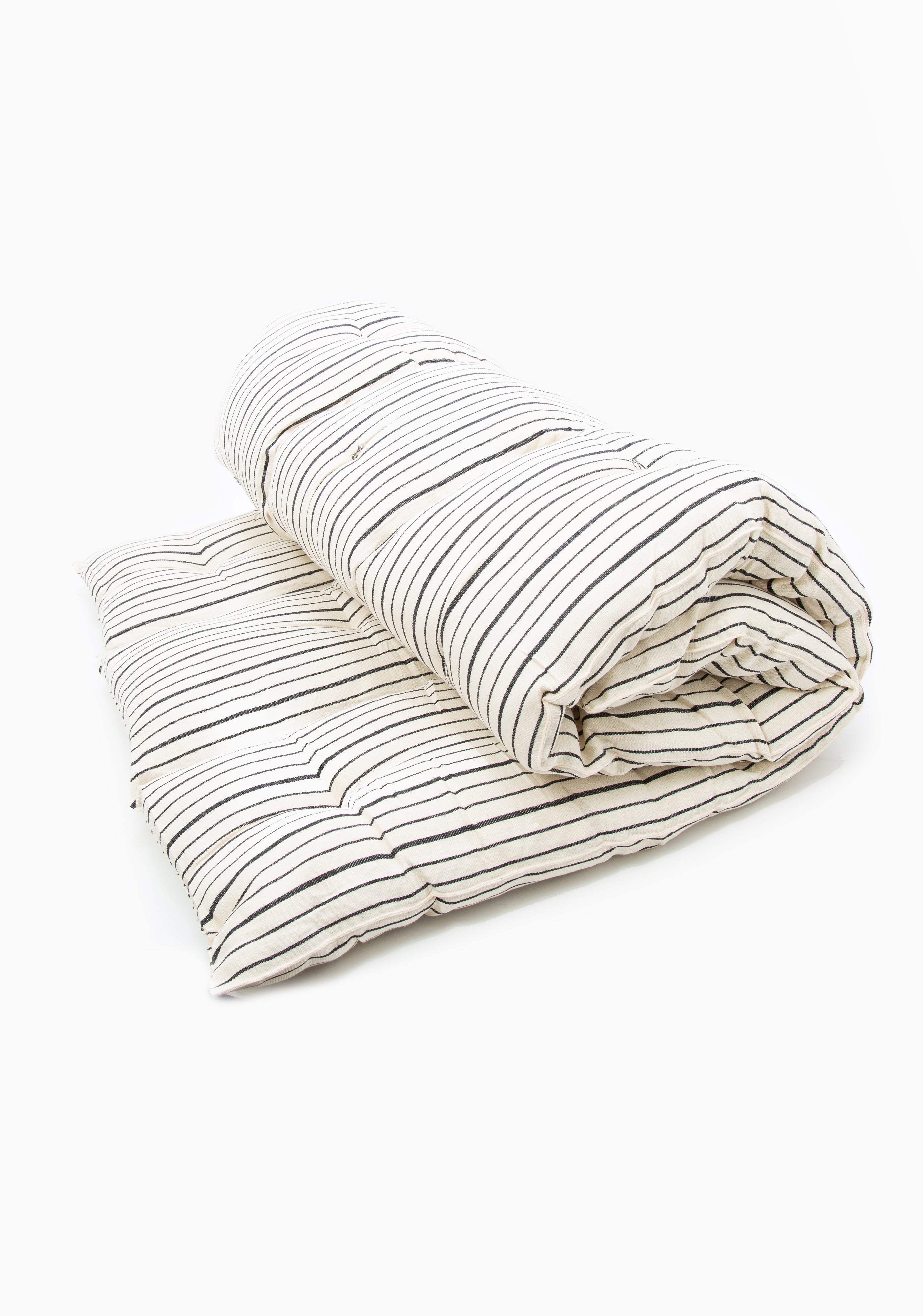 Artisan-made bed roll with natural color palette and striped design, perfect for picnics, beach days, or backyard naps.