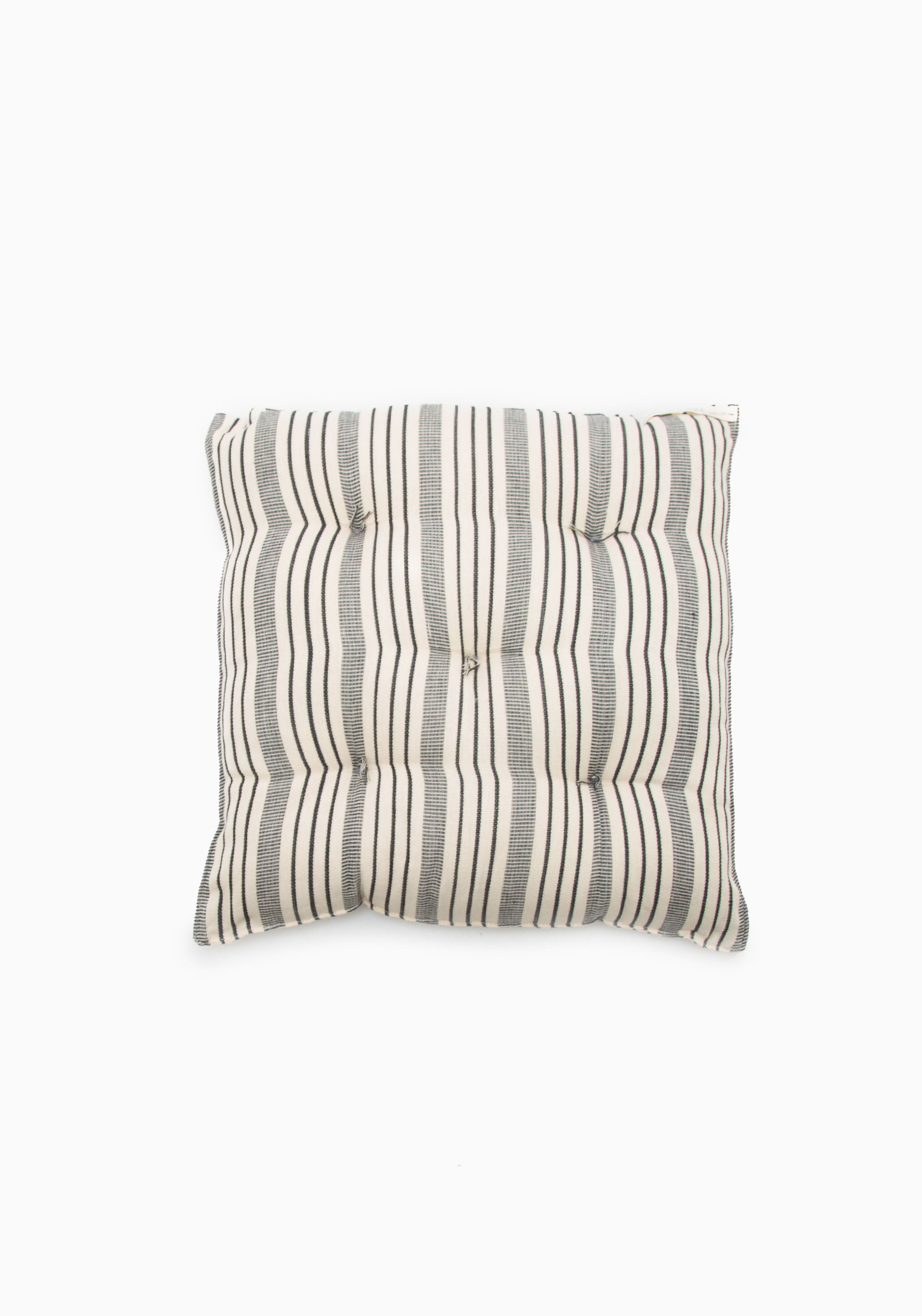 Tensira x DIANI tufted chair cushion made from 100% handwoven cotton, featuring traditional West African craftsmanship and sustainable materials.