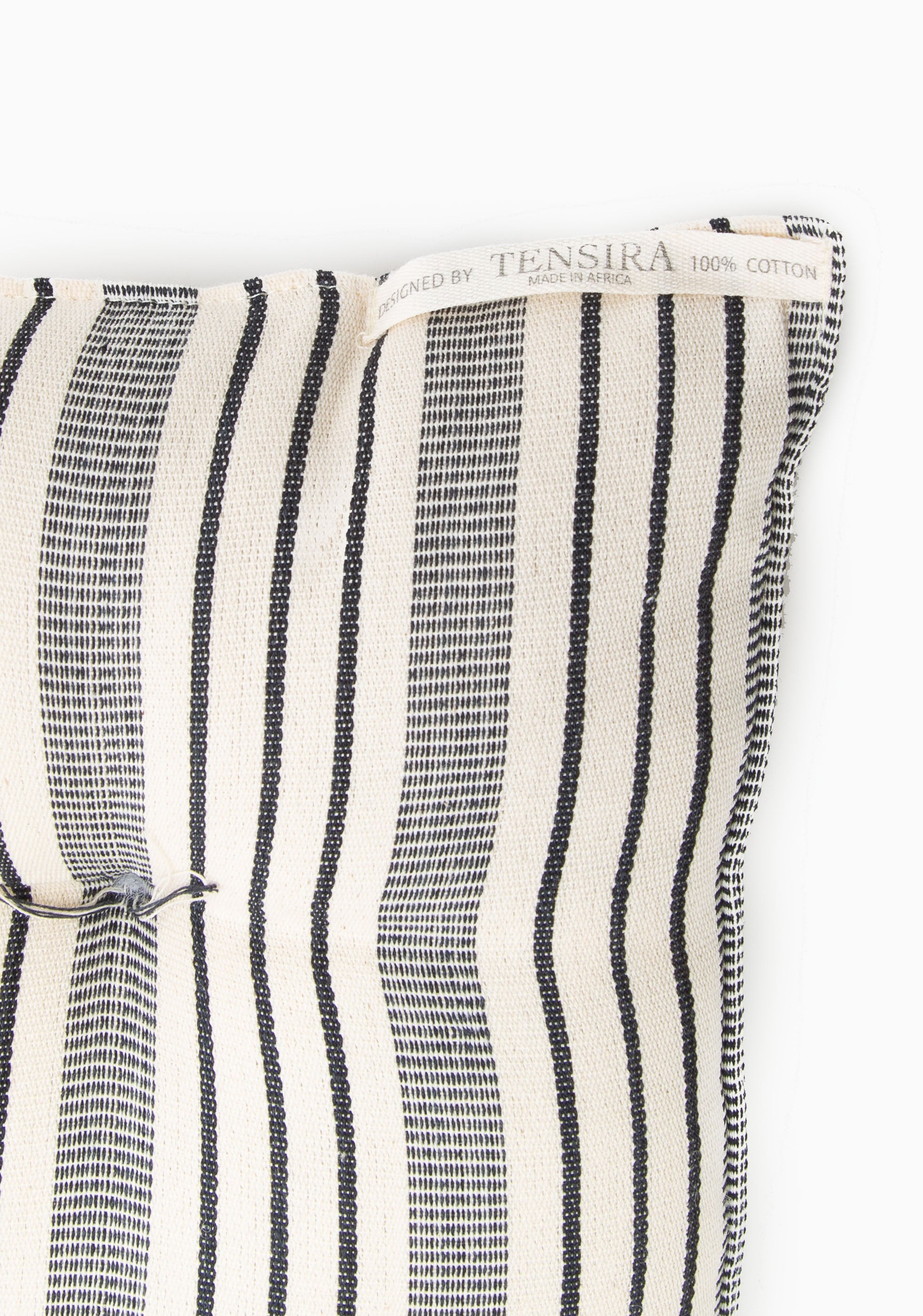 Tensira x DIANI tufted chair cushion showcasing artisan-made cotton fabric in natural tones, ideal for indoor or outdoor seating.