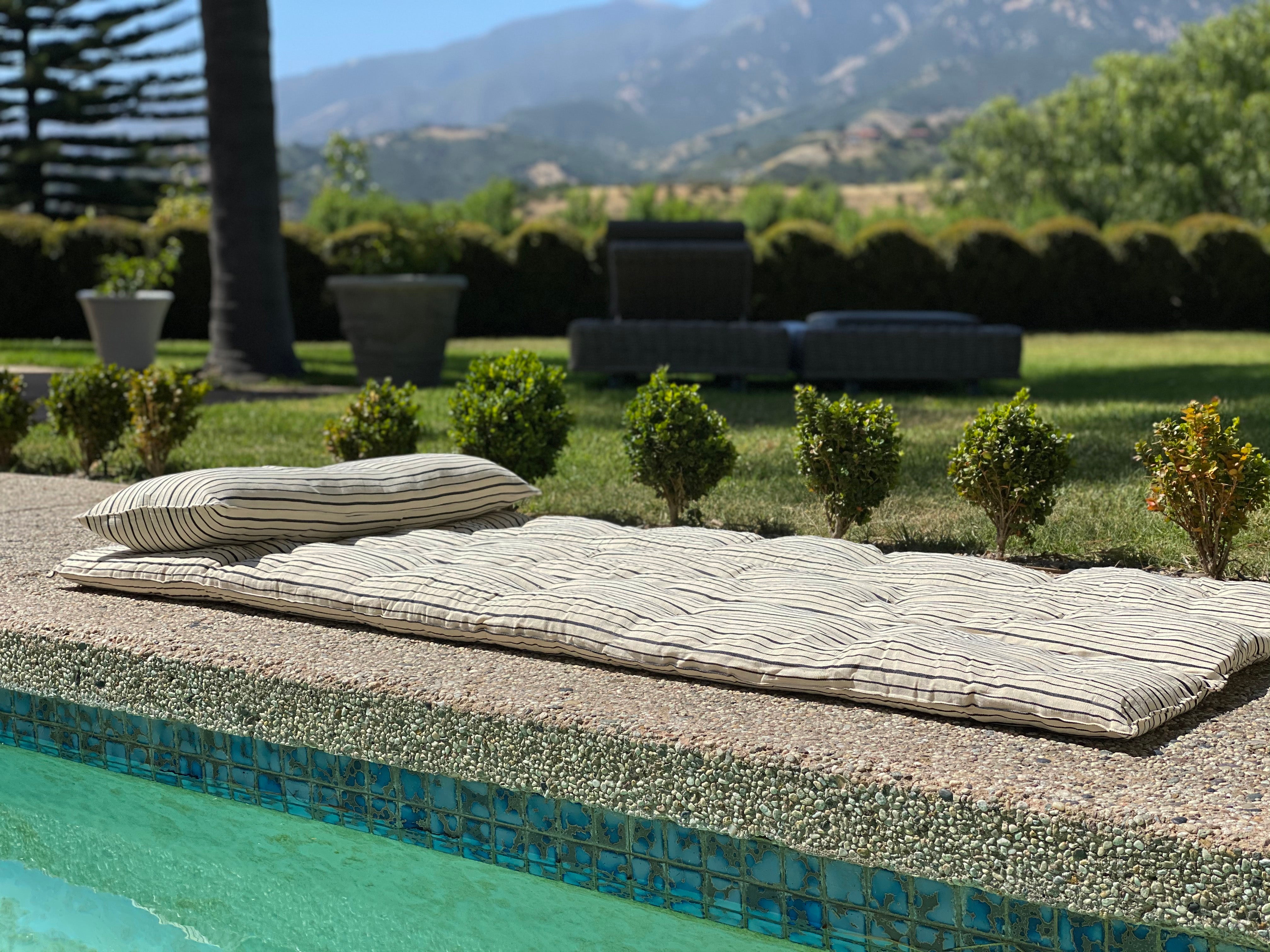 Soft and durable handwoven cotton bed roll in a striped pattern, thoughtfully designed for versatile indoor and outdoor use. Part of the Diani X Tensira collaboration.