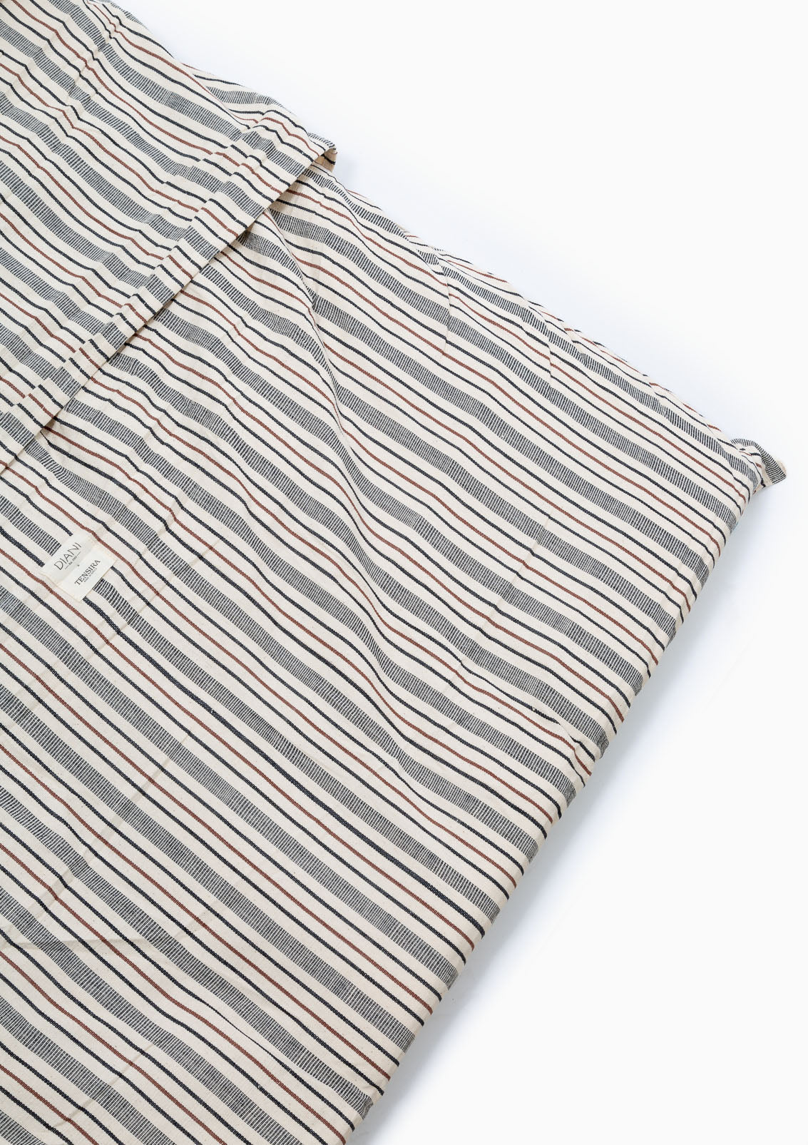 Soft and durable handwoven cotton bed roll in a striped pattern, thoughtfully designed for versatile indoor and outdoor use.
