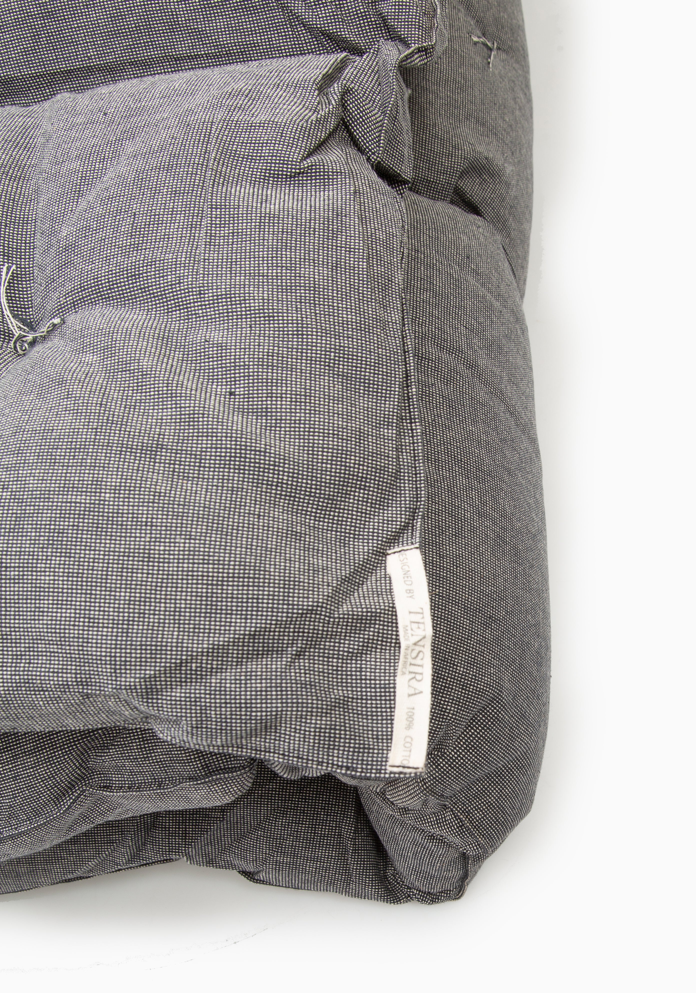 Lightweight and portable bed roll featuring hand-dyed solids or stripes, part of Caroline Diani’s globally inspired DIANI x Tensira line.