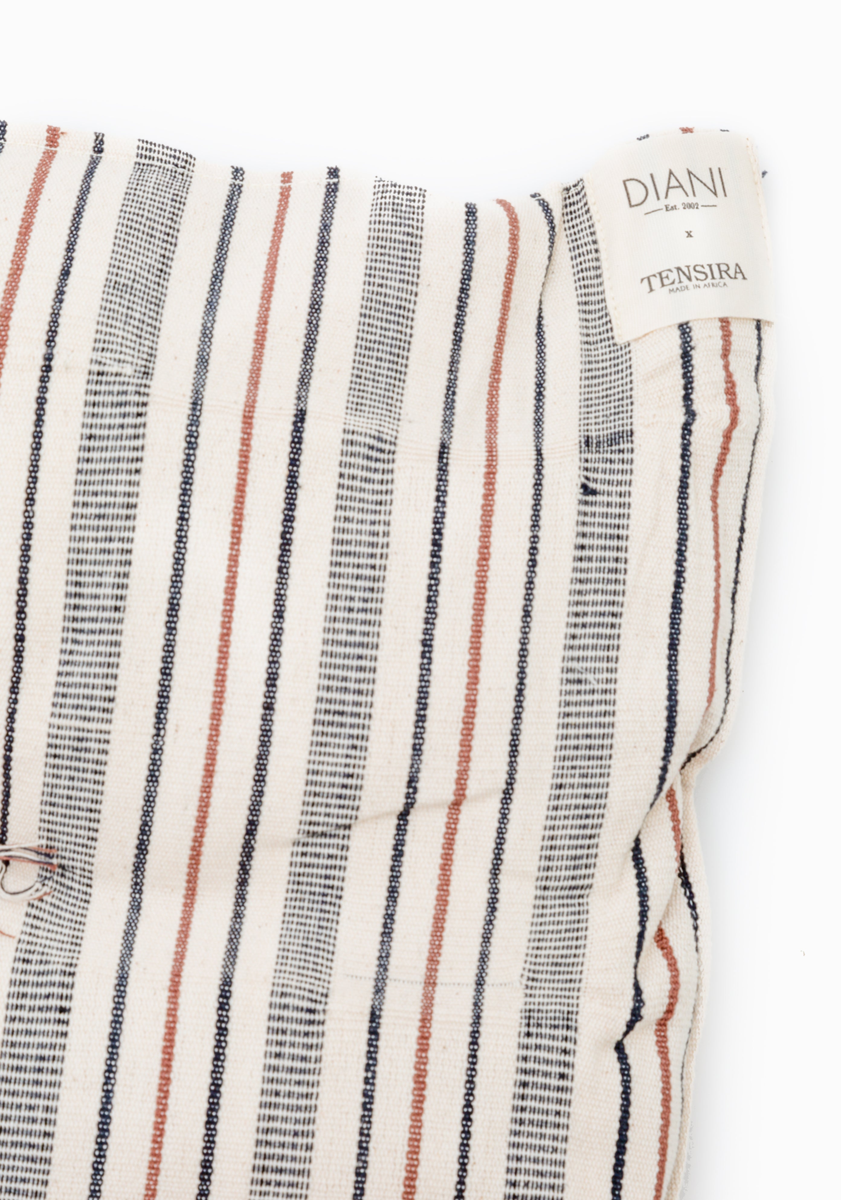 Eco-friendly cotton bed roll made with traditional West African techniques, designed for outdoor lounging and picnics.