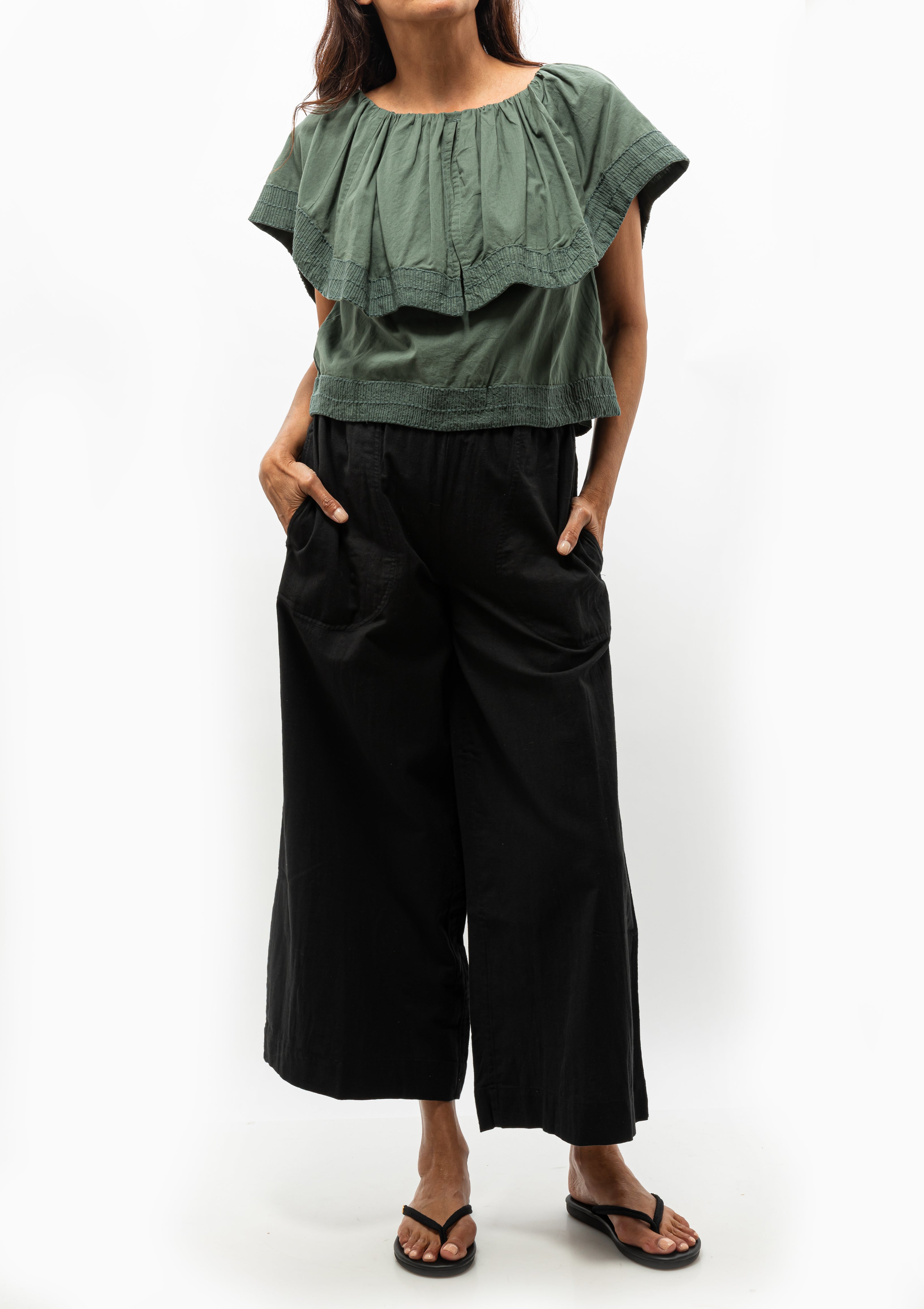 Mirth's Pondicherry Top in Verde Fossil is shown with the Mirth Black Pant and the Ancient Greek Sandal Saionara Rope. Available at Diani Boutique.
