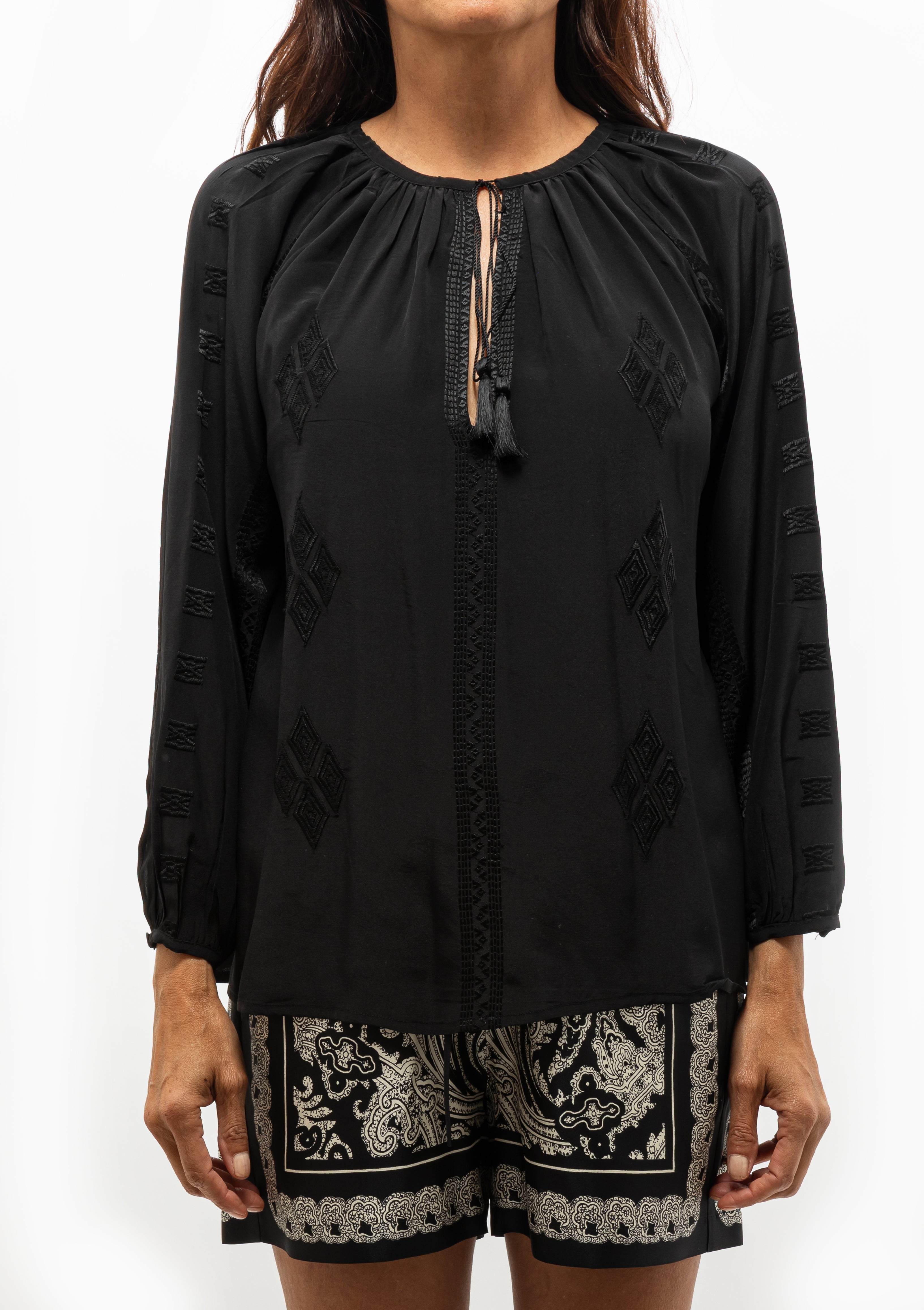 Nili Lotan Cristo Silk Blouse in classic black featuring tonal Indian embroidery, shown with the Frances Printed Silk Short — available at Diani Boutique.