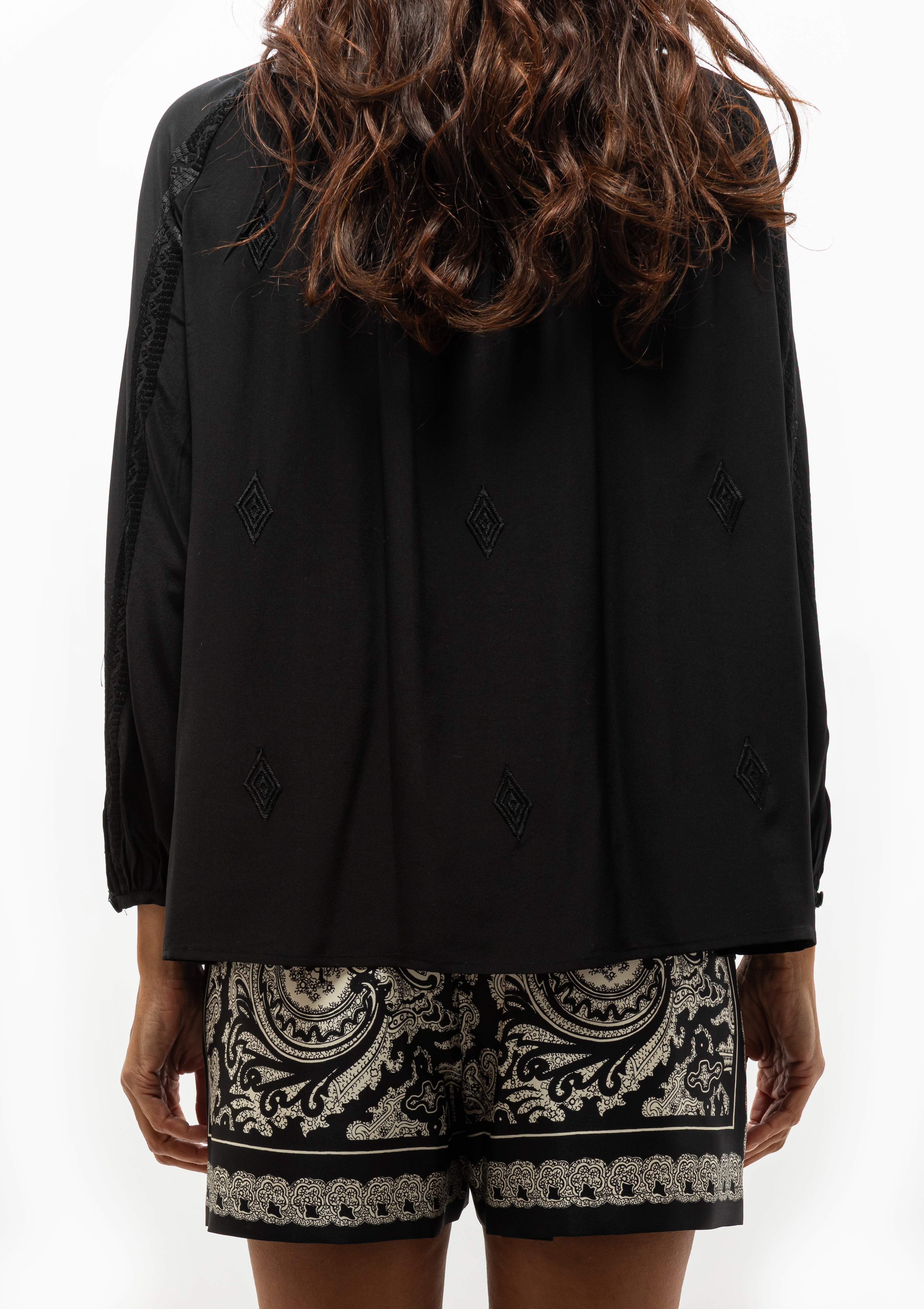 Nili Lotan Cristo Silk Blouse in classic black featuring tonal Indian embroidery, shown with the Frances Printed Silk Short — available at Diani Boutique.