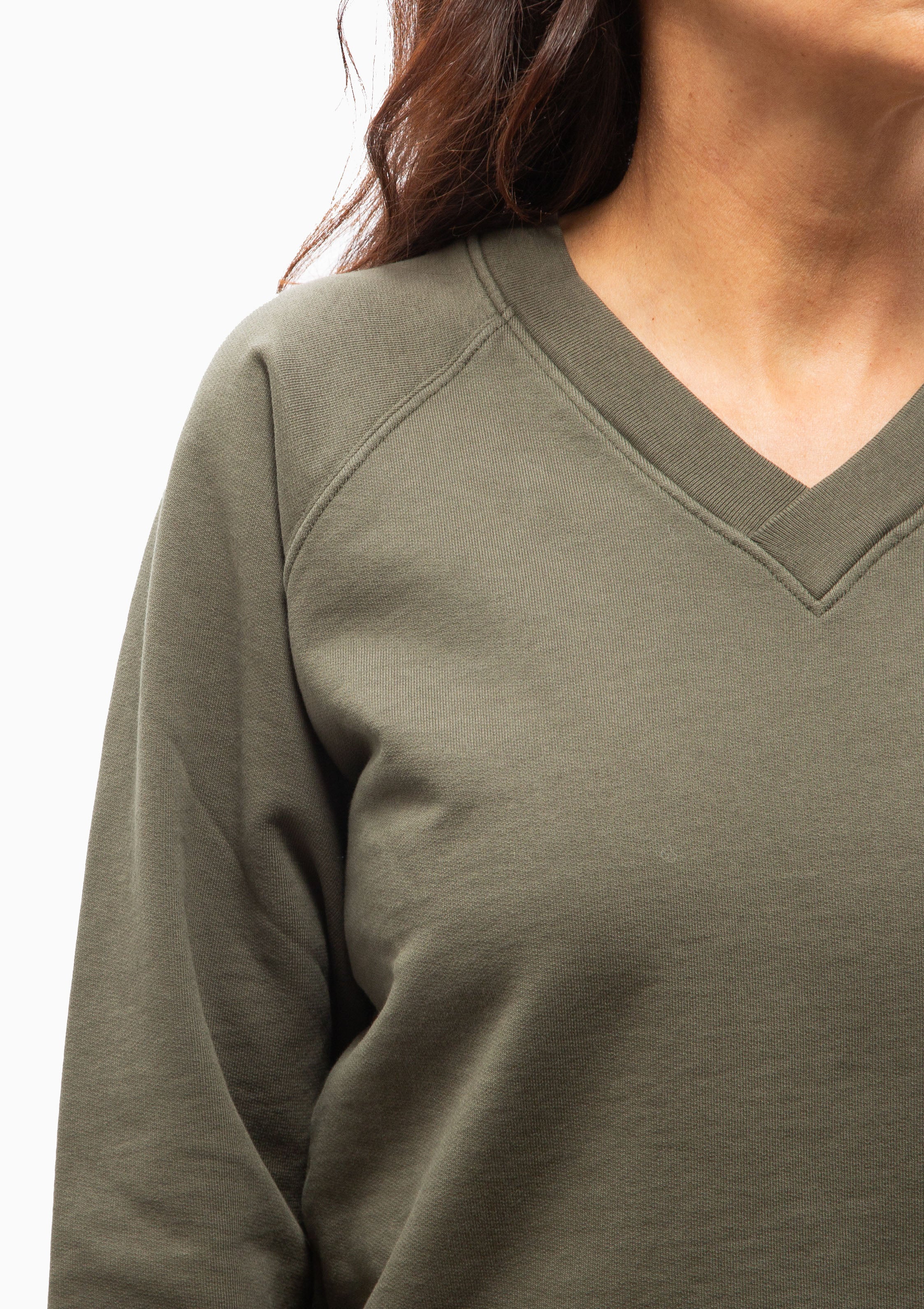 Close up of the v-neck Nili Lotan Amirah Sweatshirt in Clover. Available at Diani.