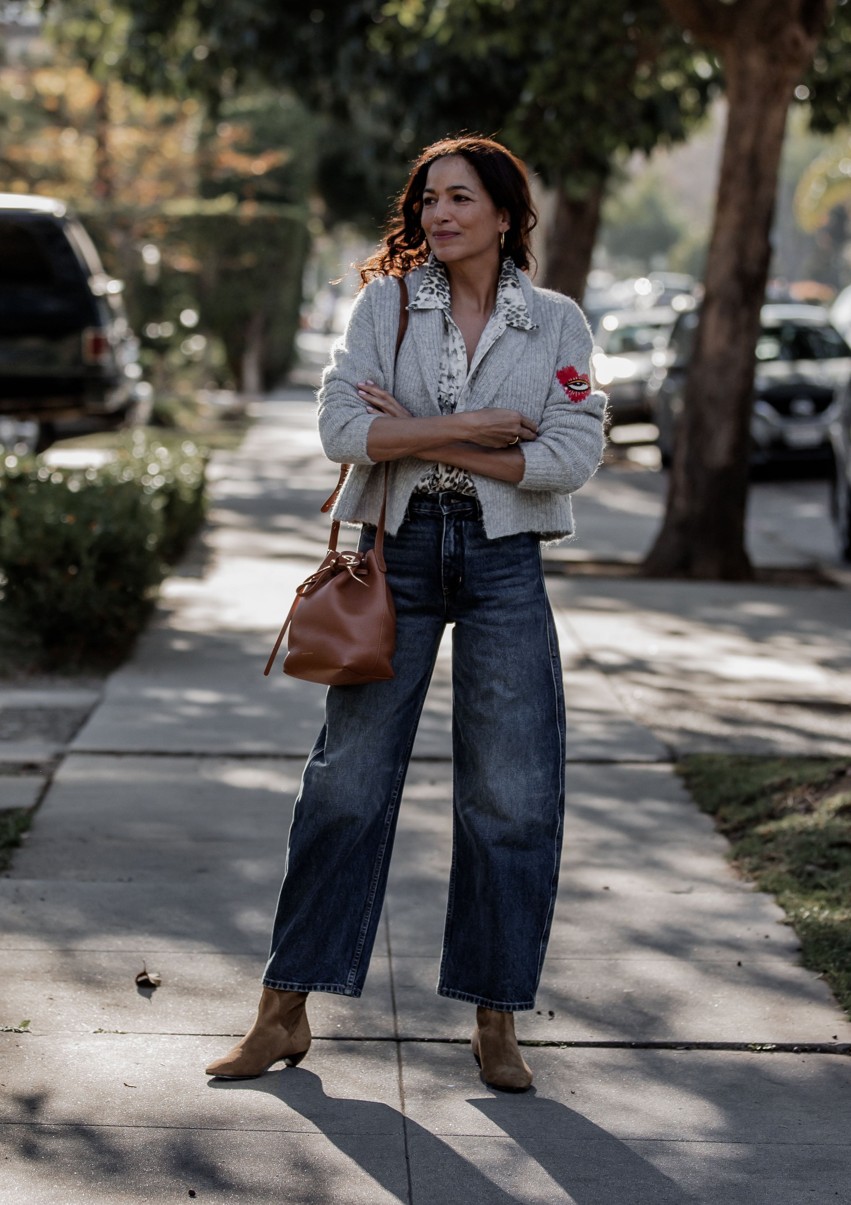 Nili Lotan Otis Jean in Simon Wash. Shown with the Allegra Ankle Boot by Le Monde Beryl in Taupe Suede and the Arcadia Cardigan in grey.  Available at Diani.